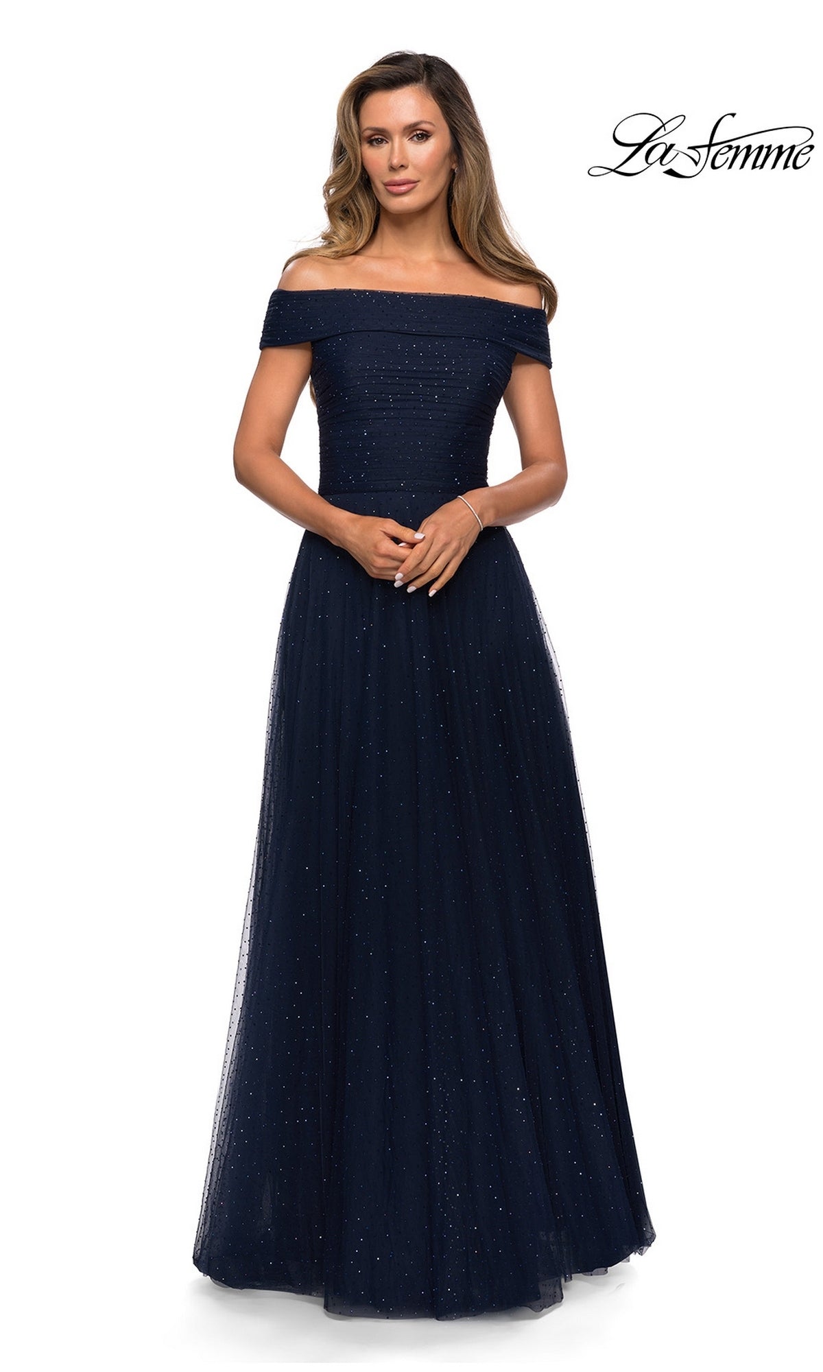 Woman in an off-the-shoulder, floor-length navy glitter dress (A-line, subtle sparkles), hands clasped; “Long Formal Dress: La Femme 28051” logo in top right corner.