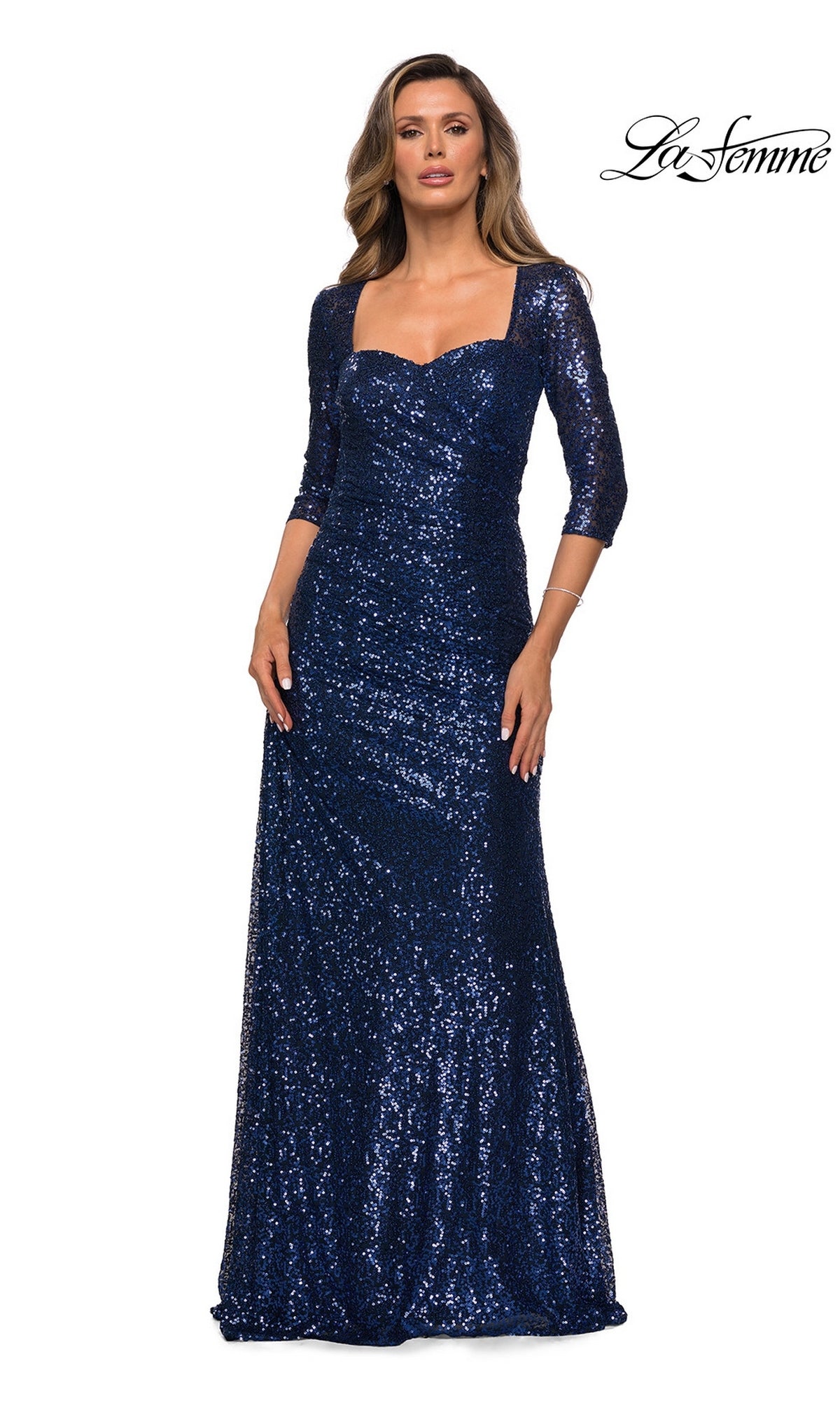 Woman wearing Long Formal Dress: La Femme 28065—navy blue sequins, three-quarter sleeves, square neckline. Perfect mother of the bride look. “La Femme” logo in top right.