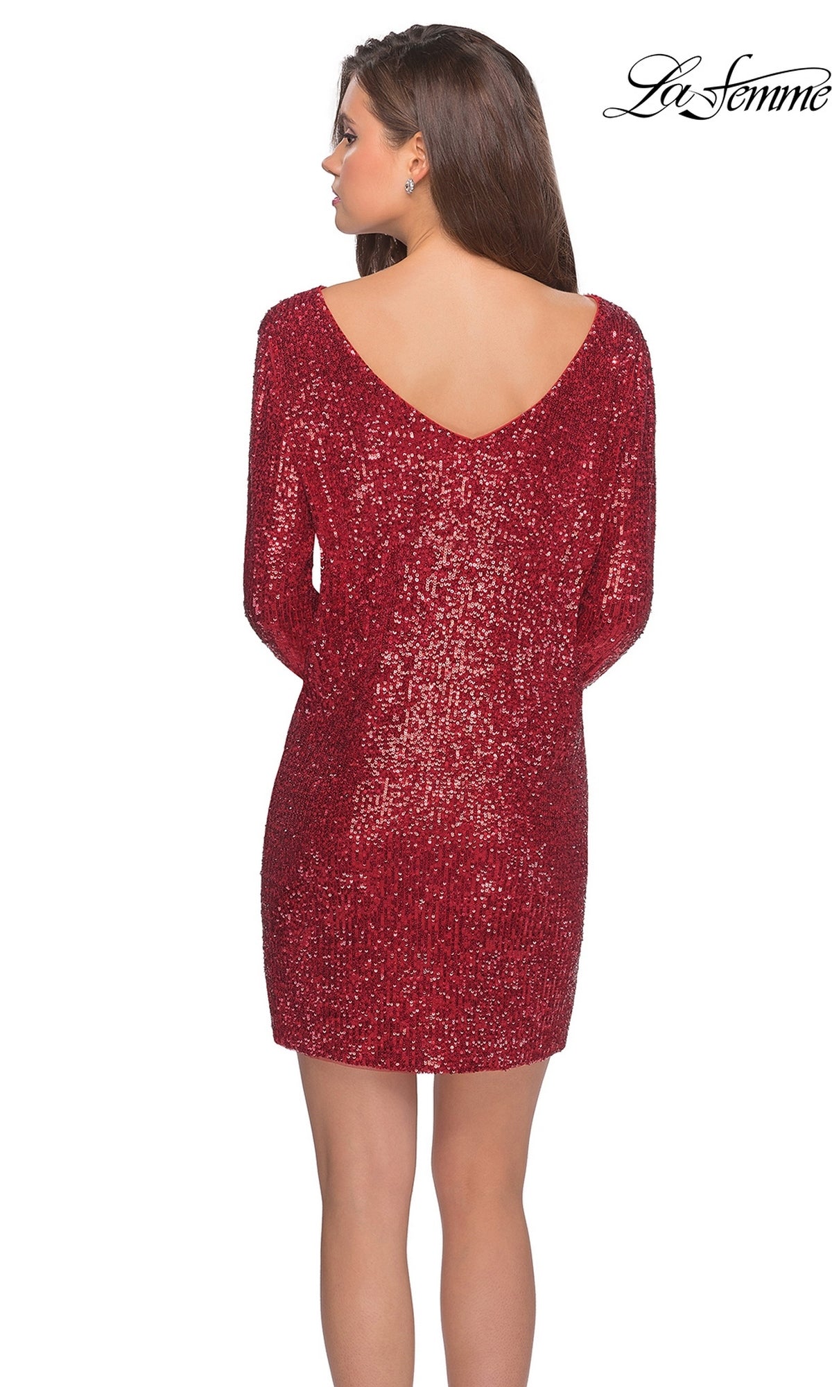 A woman stands facing away, wearing La Femme 28194, a sparkly red short sequin party dress with long sleeves and a deep V-back. The brand name “La Femme” appears in the upper right corner.