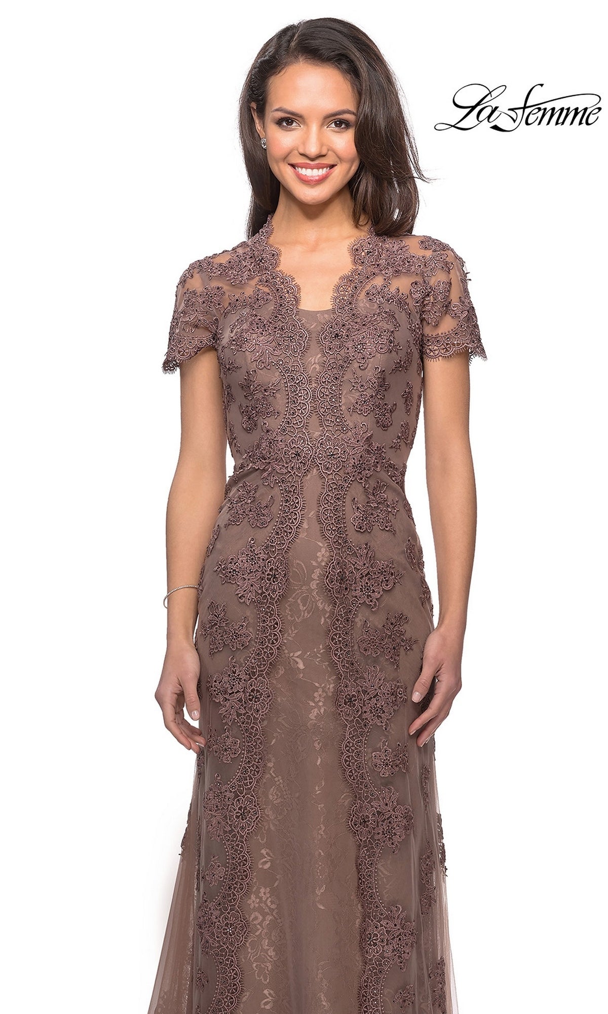 A woman wears a mauve, floor-length scalloped lace La Femme 28195 formal dress with short sleeves.