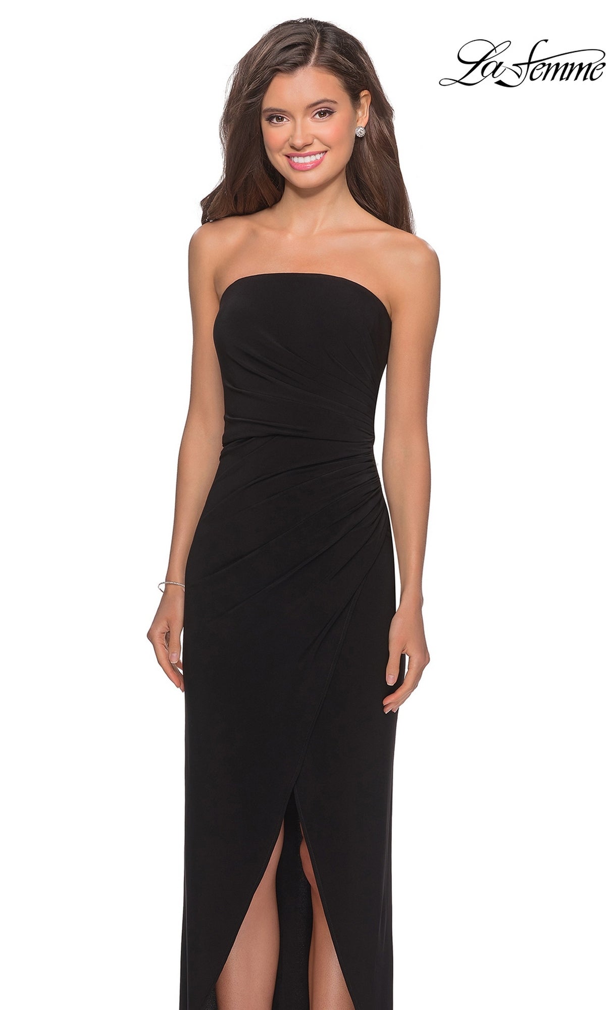 Woman wearing the Long Prom Dress: La Femme 28204 with a strapless ruched bodice, sheath skirt, and front slit, smiling against a white background.