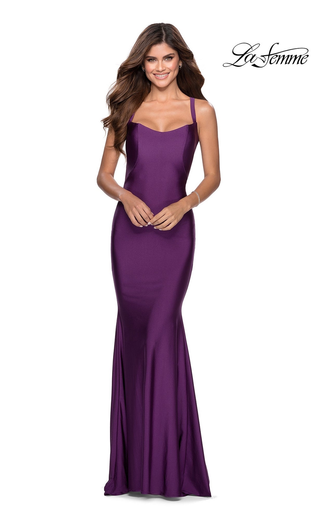 Smiling woman in a floor-length, sleeveless purple La Femme Simple Long Prom Dress 28568 with thin straps and open back, set against a white background.