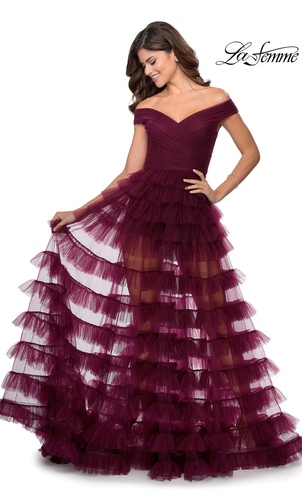 A person wearing a La Femme 28804 long prom dress, an off-the-shoulder, deep purple gown with a fitted bodice and a multi-tiered tulle skirt.