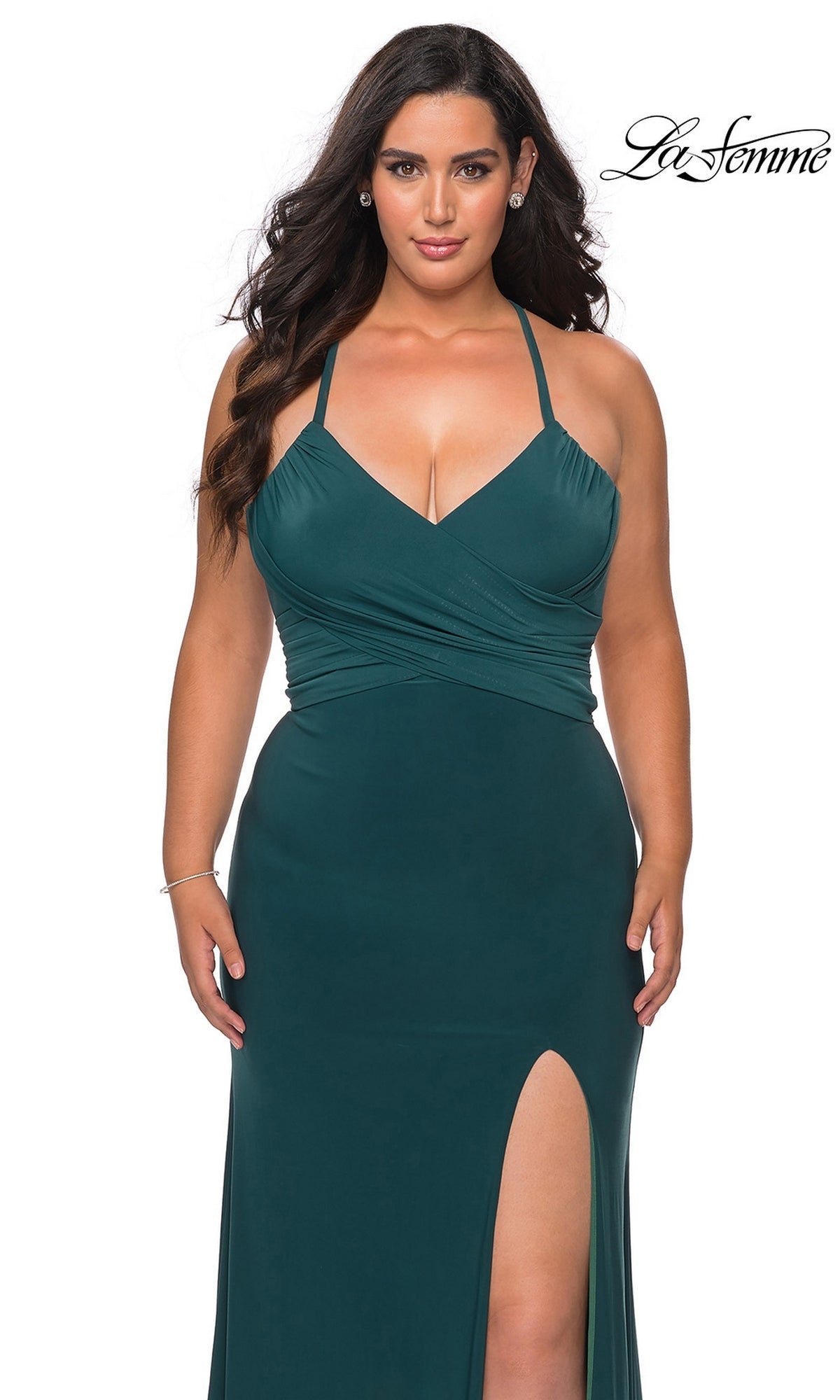 La Femme 29055 dark green, floor-length jersey prom dress with a V-neckline, spaghetti straps, a wrapped bodice, a lace-up back, and a high leg slit.