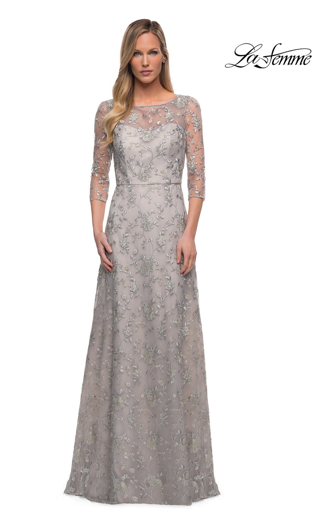 Woman in a Pearl Silver Long Formal Dress: La Femme 29153 with sheer three-quarter sleeves and floral lace, standing against a white background with “La Femme” logo.