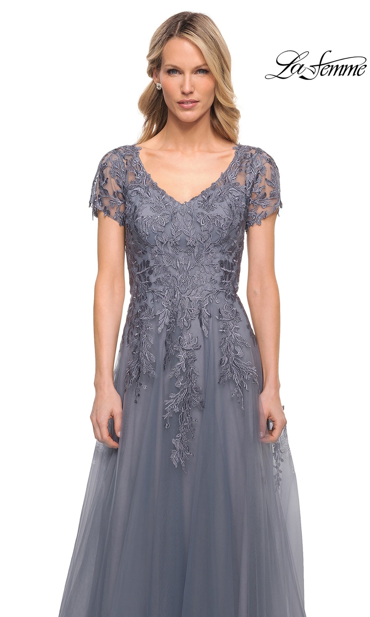 Woman wearing a slate grey, modest Long Formal Dress: La Femme 29164 with a V-neckline and floral lace embroidery on the bodice.