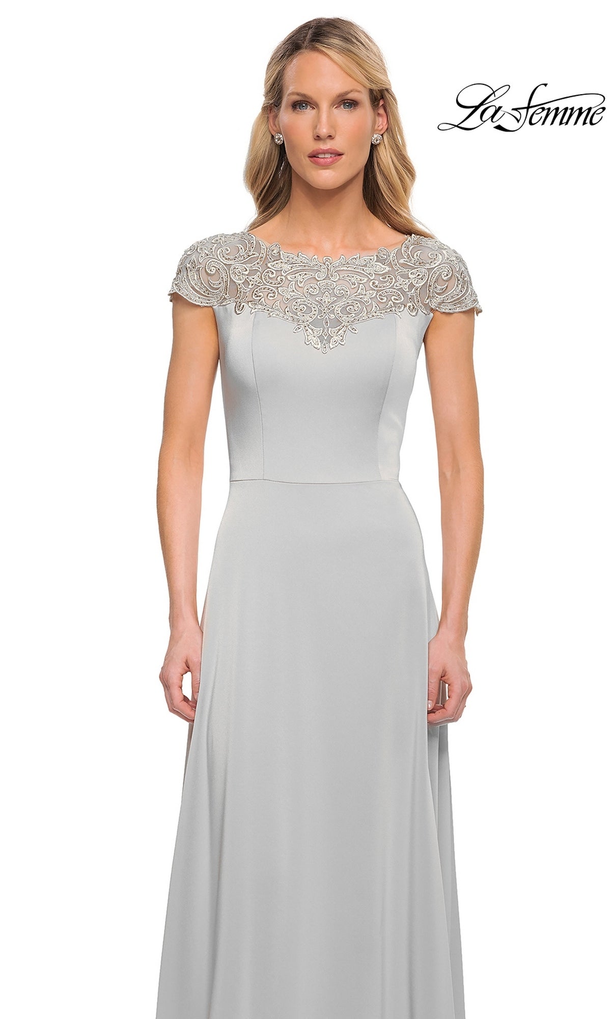 Woman wears the Long Formal Dress: La Femme 29511—a floor-length, light gray A-line gown with beaded bodice detailing. La Femme logo displayed top right.