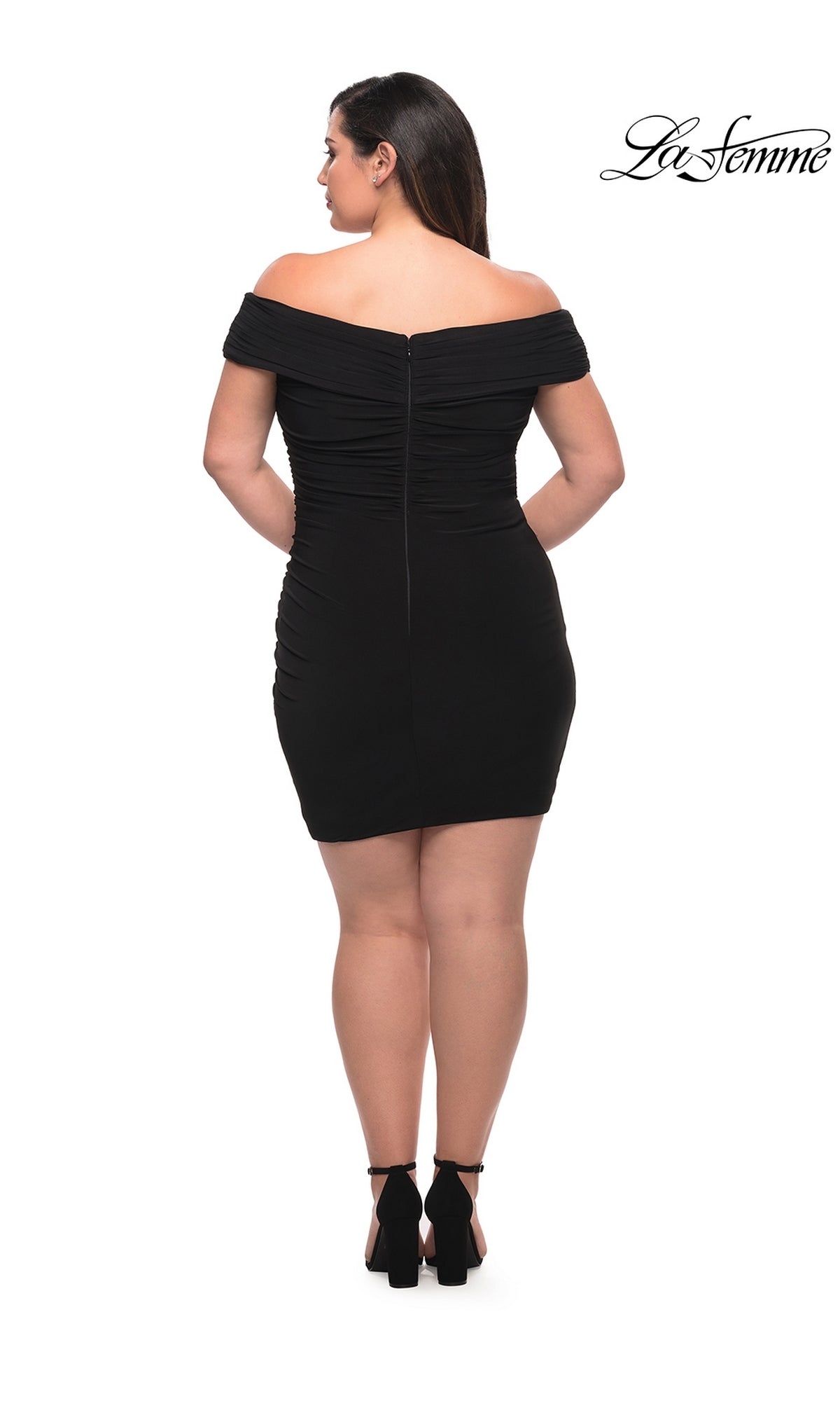 A woman faces away from the camera in a fitted, off-the-shoulder black La Femme Plus-Size Sexy Cocktail Party Dress 29521 with black heels, posed against a plain white background featuring the