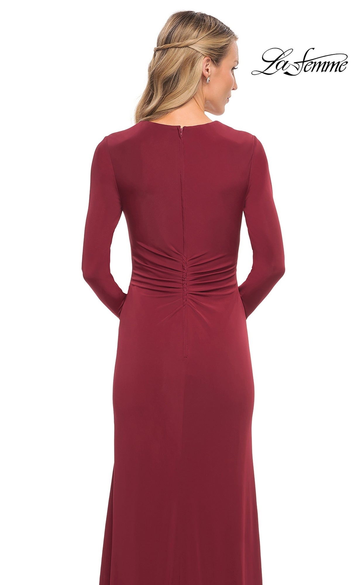 Back view of a woman wearing the Long Formal Dress: La Femme 29535, a floor-length burgundy long-sleeve gown with ruched detailing at the lower back.