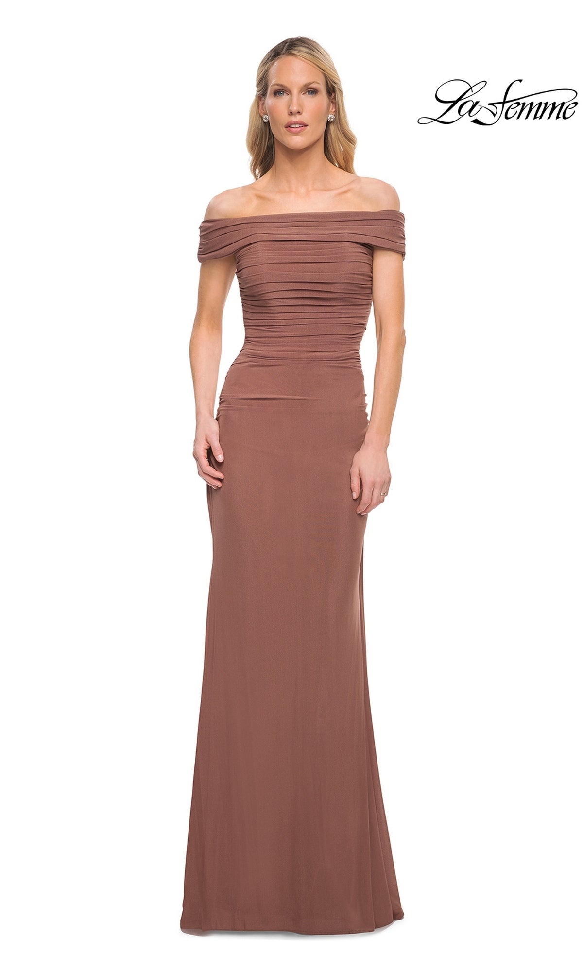 Woman wearing the Long Formal Dress: La Femme 29541 in cocoa, featuring a floor-length, off-the-shoulder neckline and ruched fitted bodice. “La Femme” logo in top right corner.