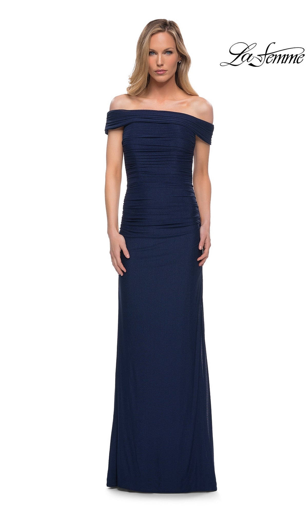 Woman in a navy Long Formal Dress: La Femme 29541 with a ruched fitted bodice, off-the-shoulder neckline, floor-length skirt. La Femme logo appears top right.
