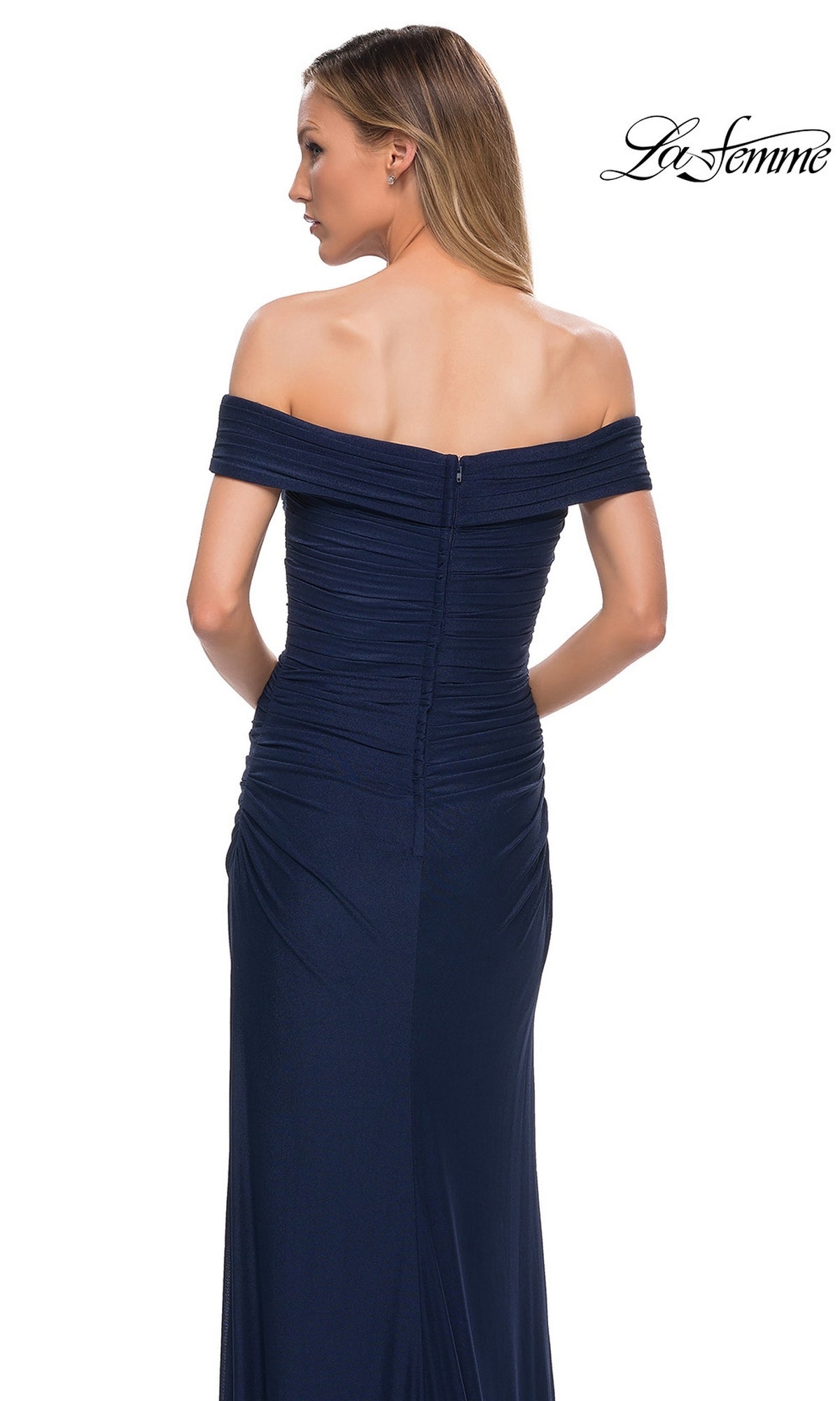 Woman wearing Long Formal Dress: La Femme 29541 in navy, off-the-shoulder style with a ruched fitted bodice and visible back zipper.