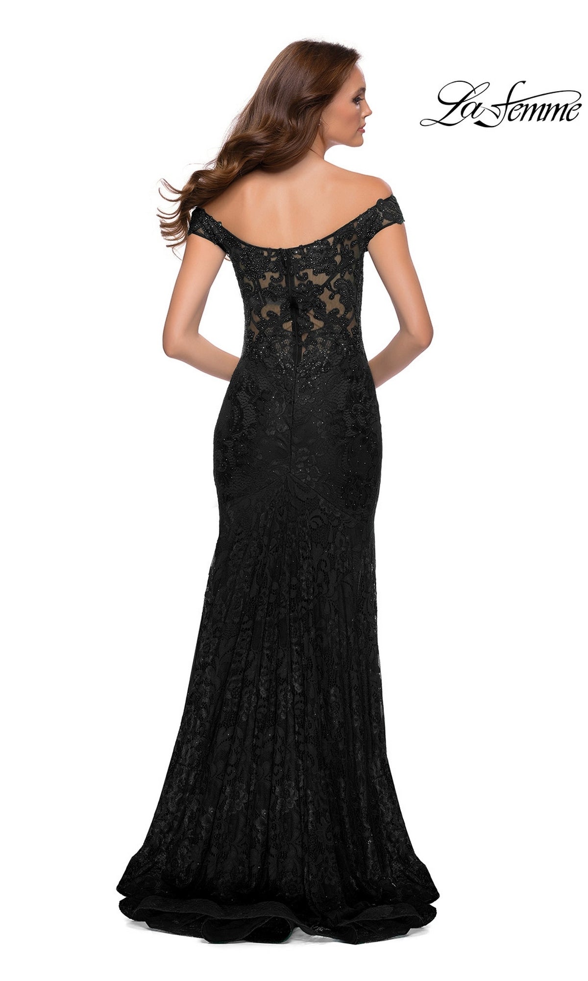 Woman in Long Prom Dress: La Femme 29693—off-shoulder, floor-length black stretch-lace with a fitted silhouette—stands with her back to the camera.