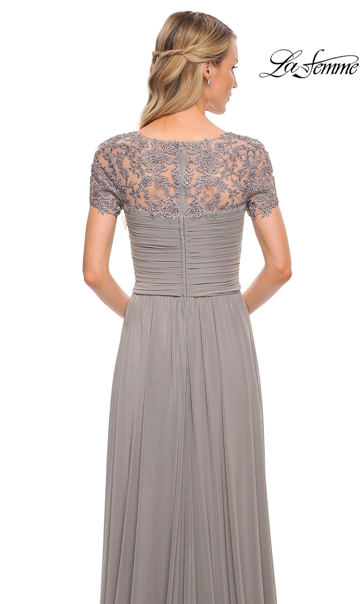 Woman in a grey gown with lace embroidered short sleeves, ruched fitted bodice, and A-line skirt. Long Formal Dress: La Femme 29772 logo in the top right corner.