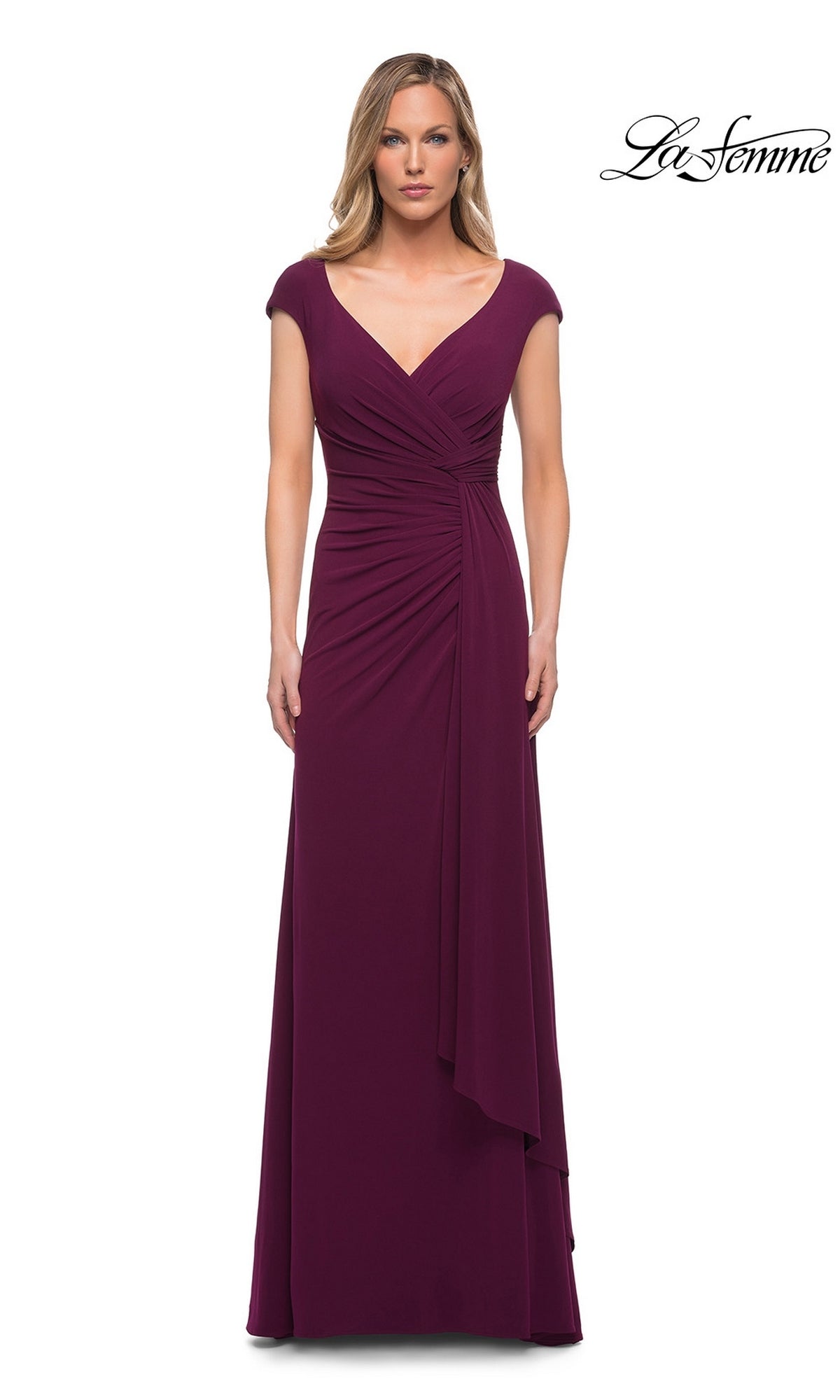 A woman wears a dark berry Long Formal Dress: La Femme 29814 featuring cap sleeves, a v-neckline, and a cascading ruffle detail gathered at the waist.