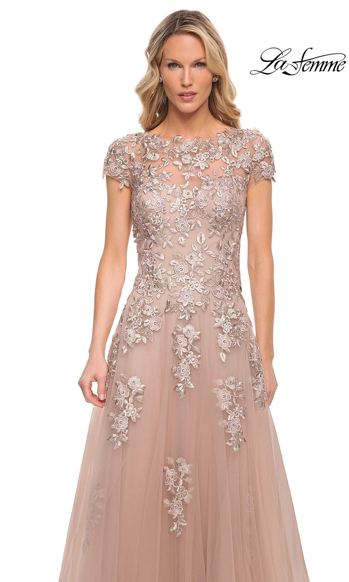 La Femme 29829 is a floor-length blush formal dress with a cap-sleeve bodice featuring sheer floral embroidery over a light pink skirt.