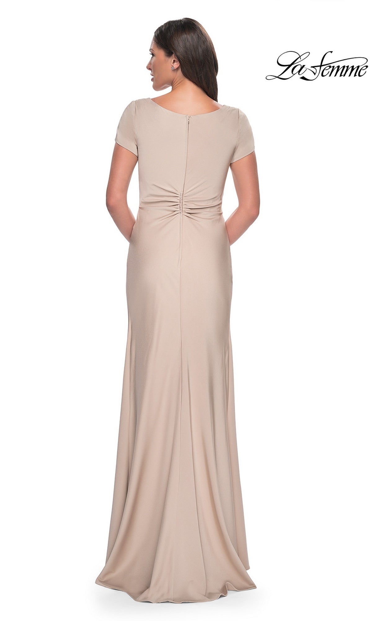 Woman seen from behind wearing a beige Long Formal Dress: La Femme 29926, a short-sleeved, floor-length gown with a gathered waist detail.