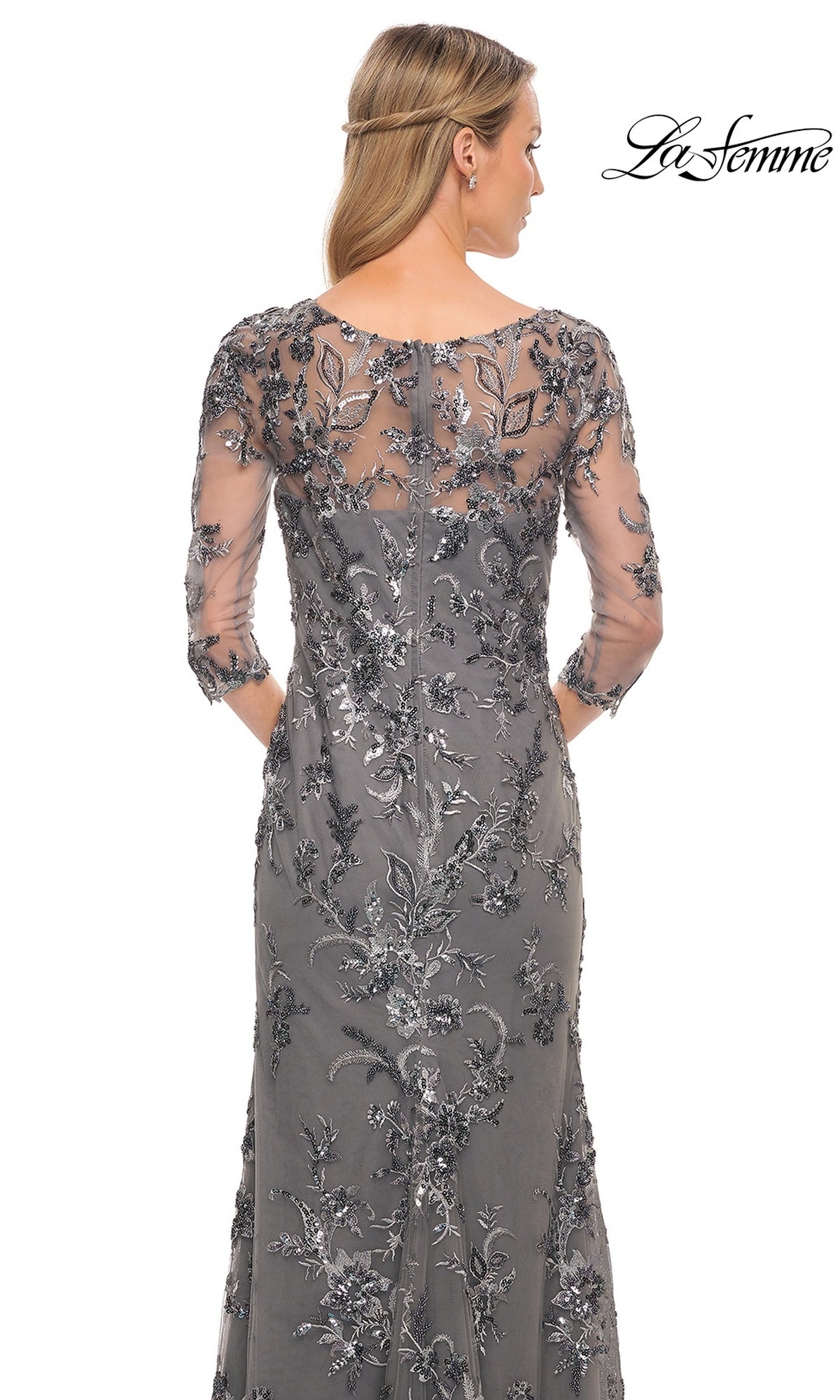 Back view of the Long Formal Dress: La Femme 29976, a modest silver-grey gown with three-quarter sleeves and a sheer floral-embroidered overlay featuring silver sequins.