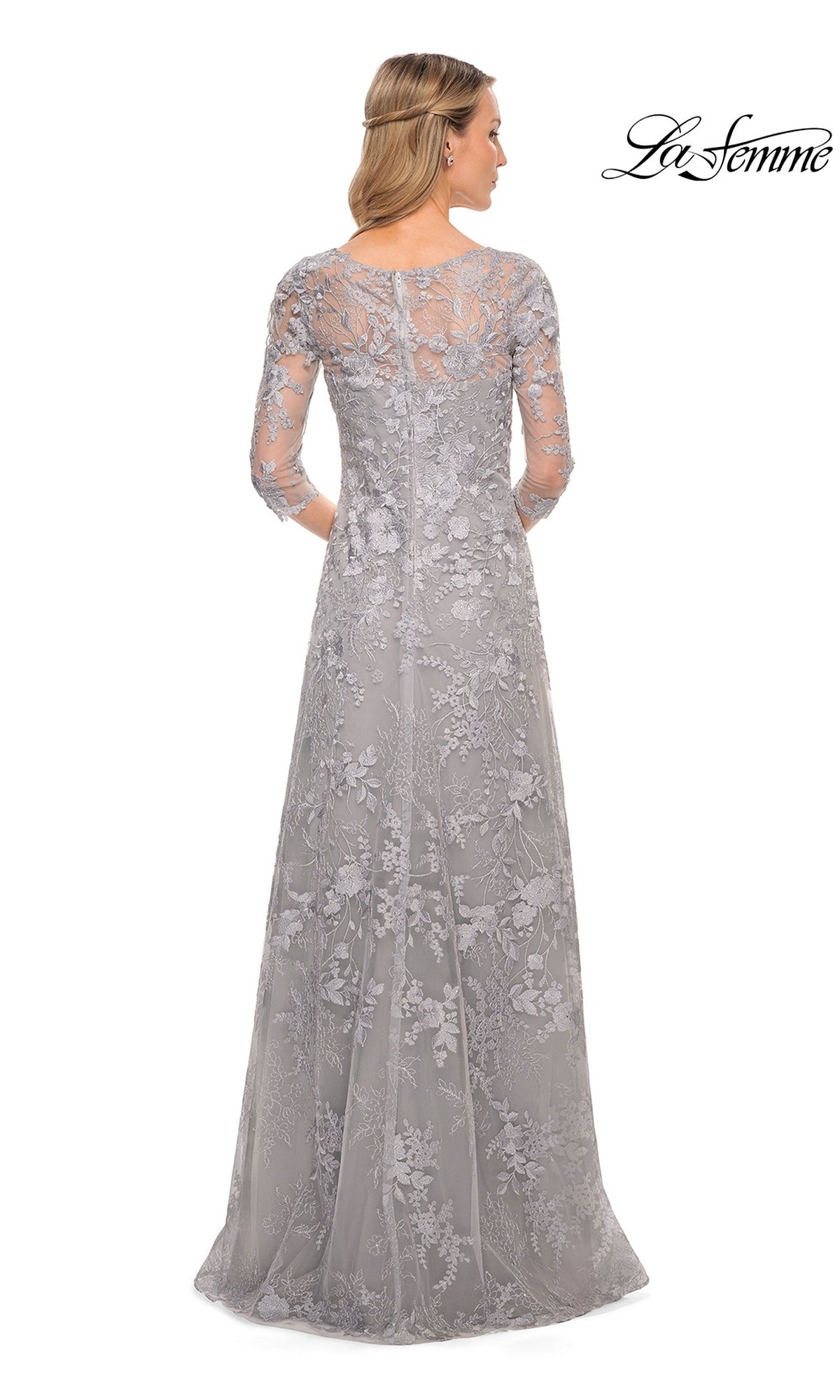 Back view of a woman in a floor-length gray La Femme 29989 mother of the bride dress featuring three-quarter sleeves and a floral lace overlay.