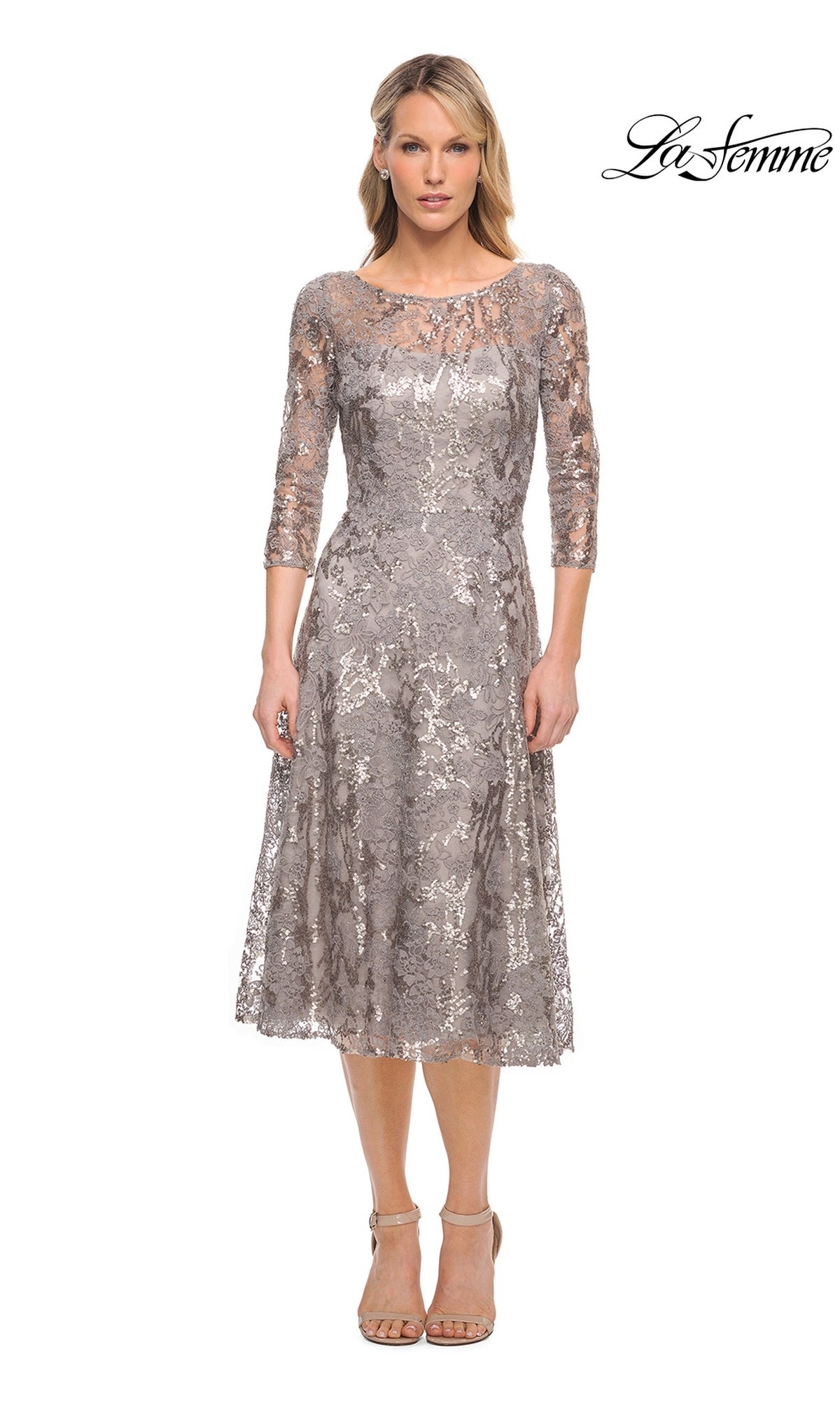 A woman wearing a silver, three-quarter sleeve metallic lace midi dress with sequin detailing, the La Femme 29993 wedding guest dress.