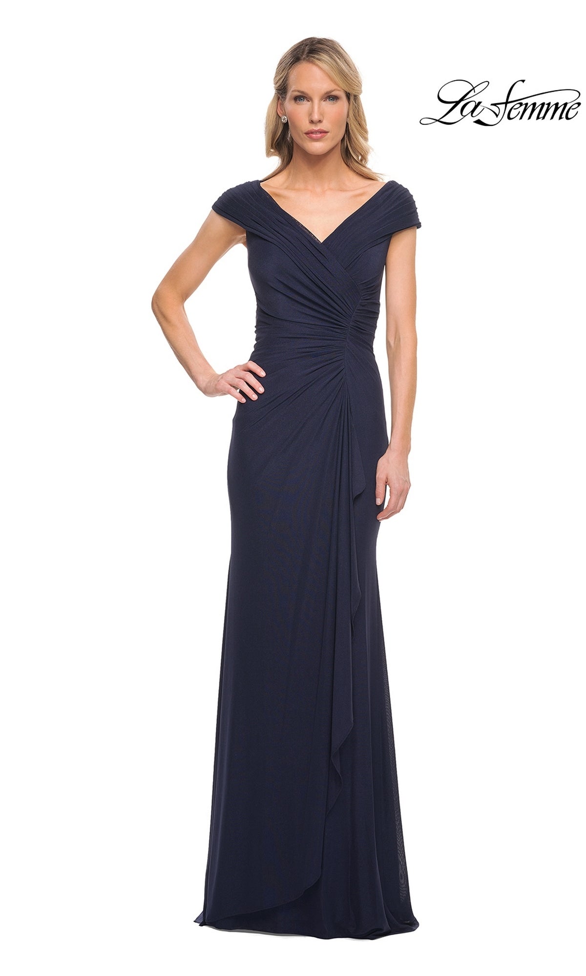 A woman wears a navy Long Formal Dress: La Femme 29996, a floor-length formal gown with a v-neckline, cap sleeves, and draped detailing at the bodice.
