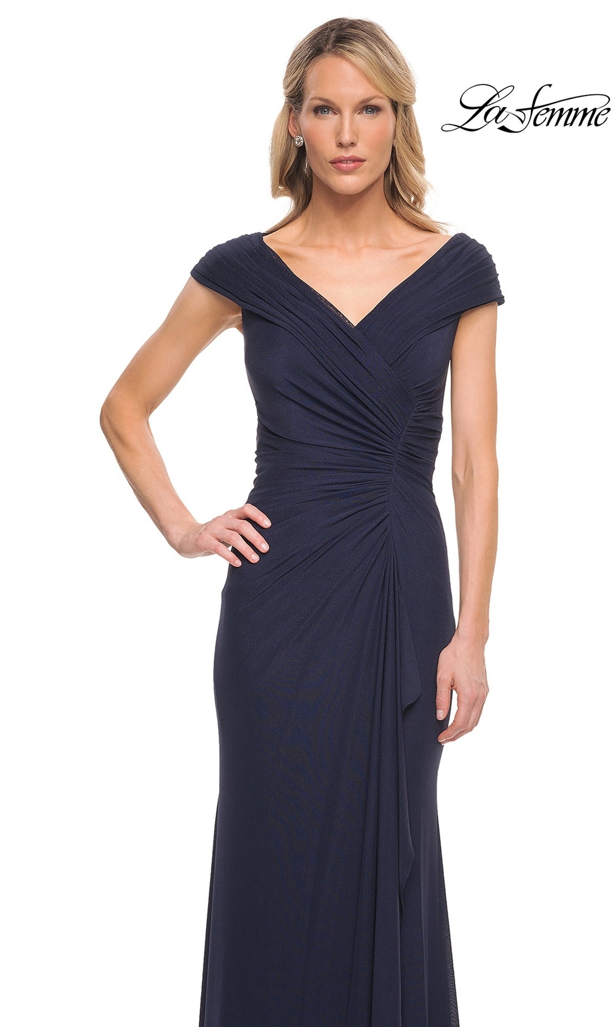 A woman wears a dark blue, floor-length Long Formal Dress: La Femme 29996, featuring cap sleeves and a draped, pleated bodice.