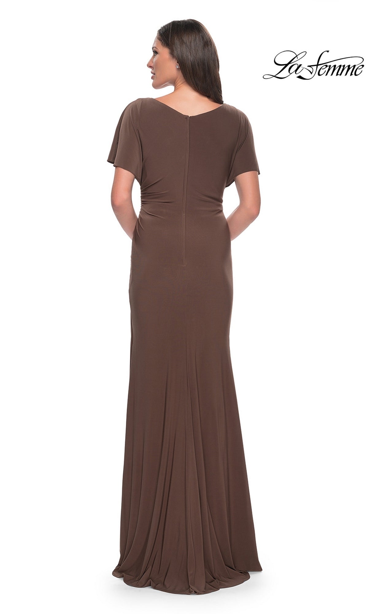 A person viewed from the back wearing a La Femme 29997, a brown V-neckline formal dress with a floor-length sheath skirt.