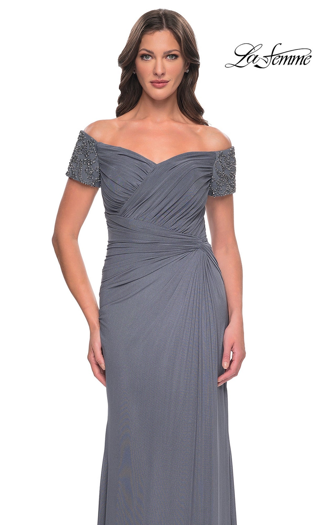 Woman in a grey beaded sheath dress with off-the-shoulder sleeves, standing against a white background. Long Formal Dress: La Femme 30057 logo appears in the top right corner.