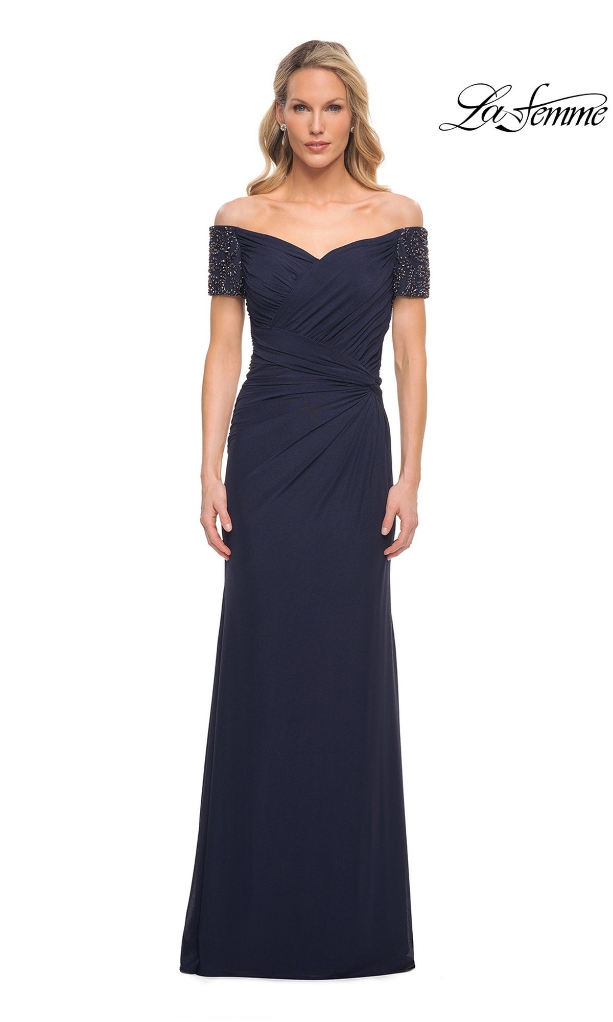 A woman faces forward in a navy Long Formal Dress: La Femme 30057 with beaded off-the-shoulder sleeves; the La Femme logo is in the top right corner.