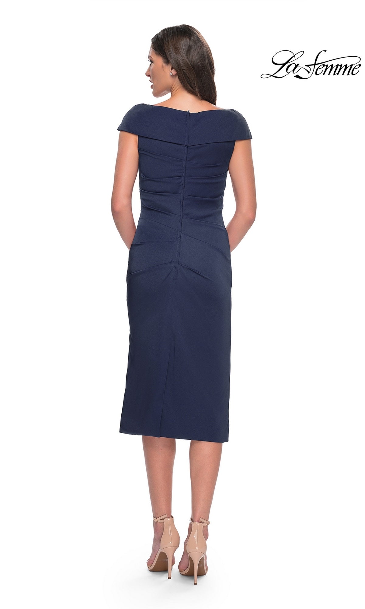 Back view of a woman wearing a navy blue jersey Midi Wedding Guest Dress: La Femme 30110 with a fold-over neckline and nude high heels.