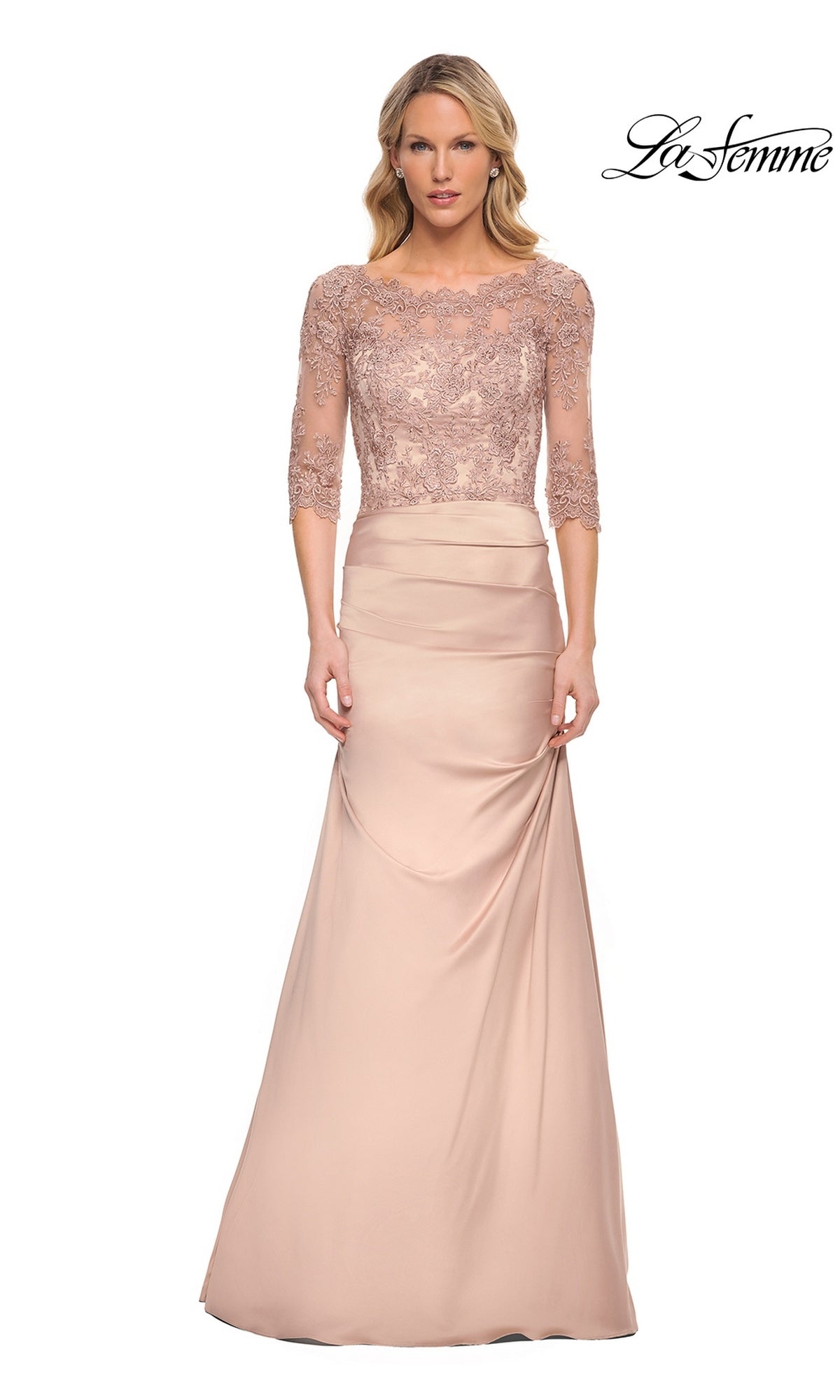Woman in a Long Formal Dress: La Femme 30162 in champagne with lace three-quarter sleeves and fitted satin skirt, standing against a white background. “La Femme” logo top right.