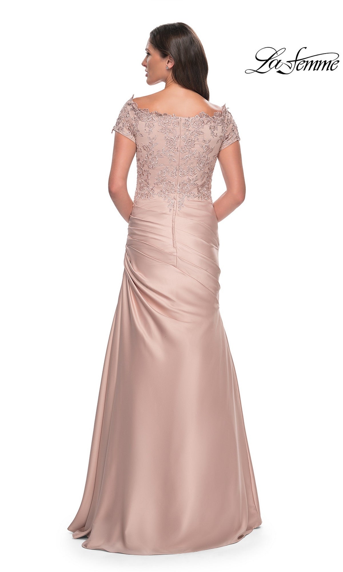 Back view of the blush-colored, floor-length La Femme 30199 mother of the bride dress, featuring an off-the-shoulder lace bodice and a ruched skirt.