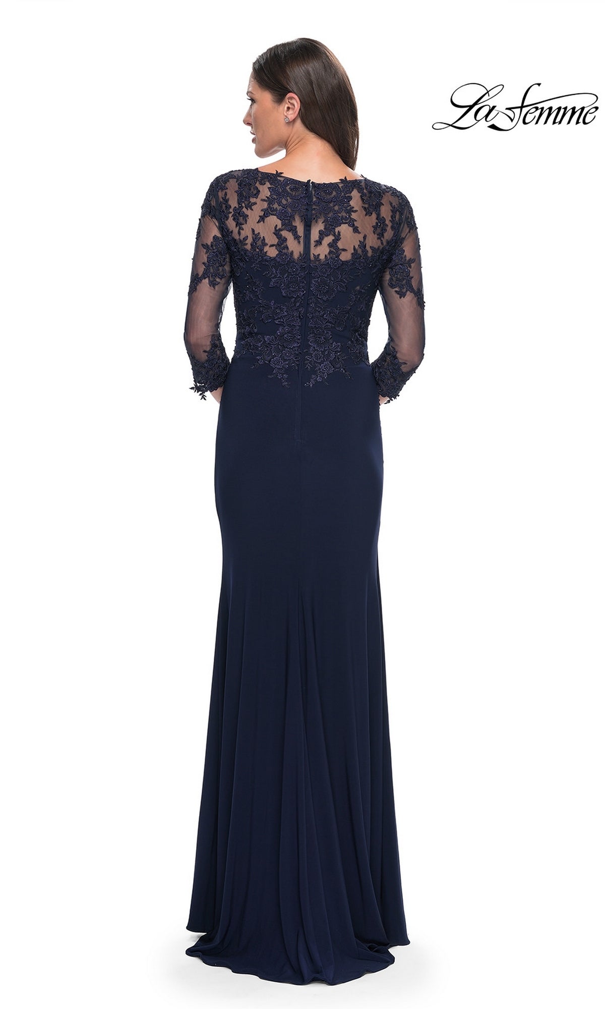A woman faces away wearing the Long Formal Dress: La Femme 30384 in navy blue, featuring sheer lace sleeves and an embroidered lace back. The La Femme logo is in the top right corner.