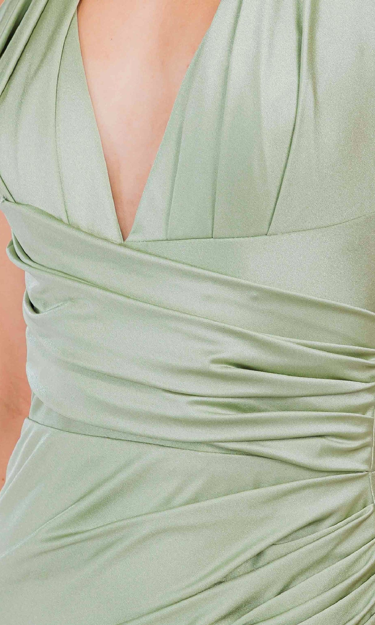 Close-up of a person wearing the Amelia Couture 3040 V-Neck Long Halter Prom Dress in light green, featuring ruched fabric, a deep V-neckline, and elegant draped detailing.