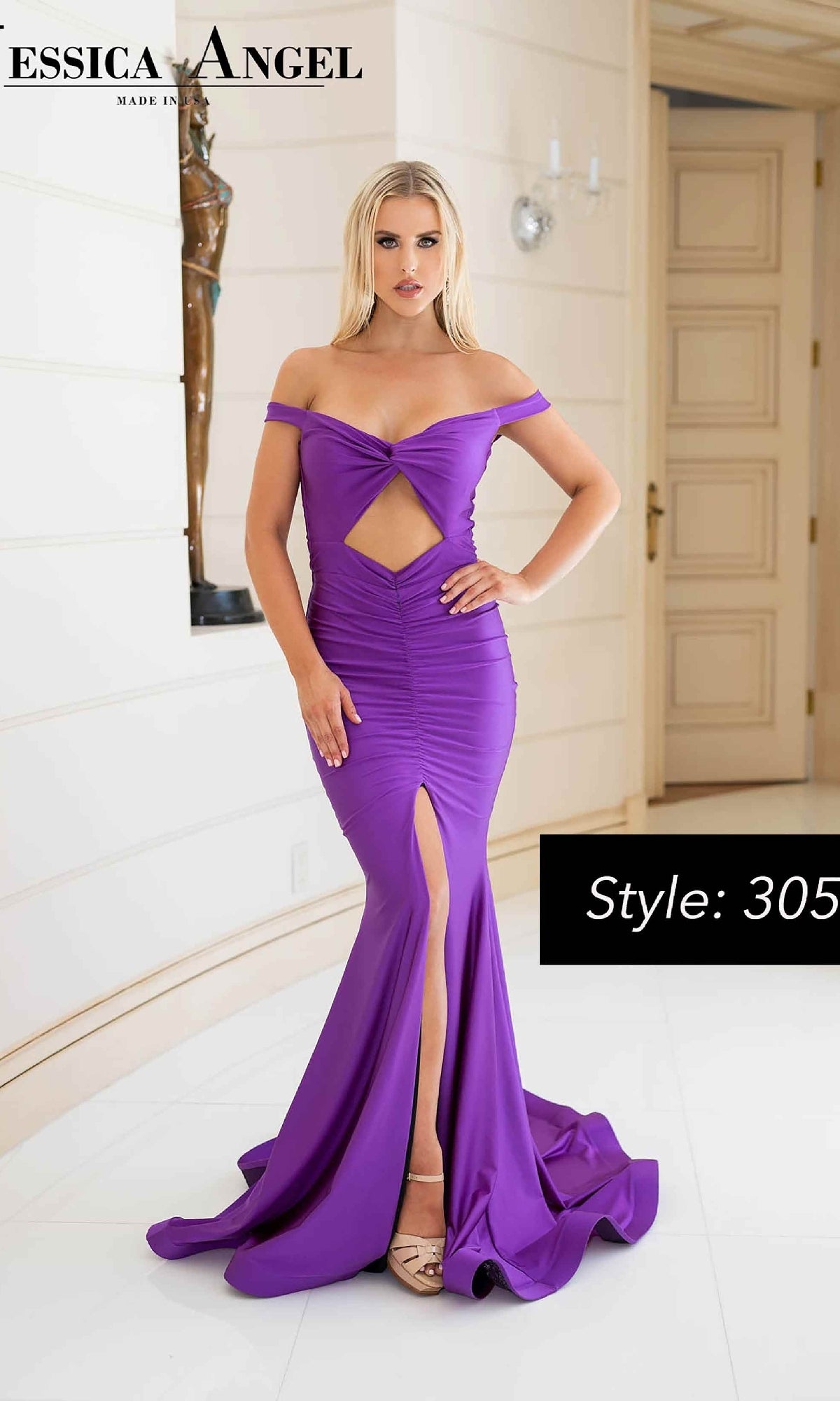 A woman in a fitted Jessica Angel 305 Cut-Out Long Prom Dress with an off-the-shoulder neckline, front slit, and cutout stands indoors near a door. Text reads