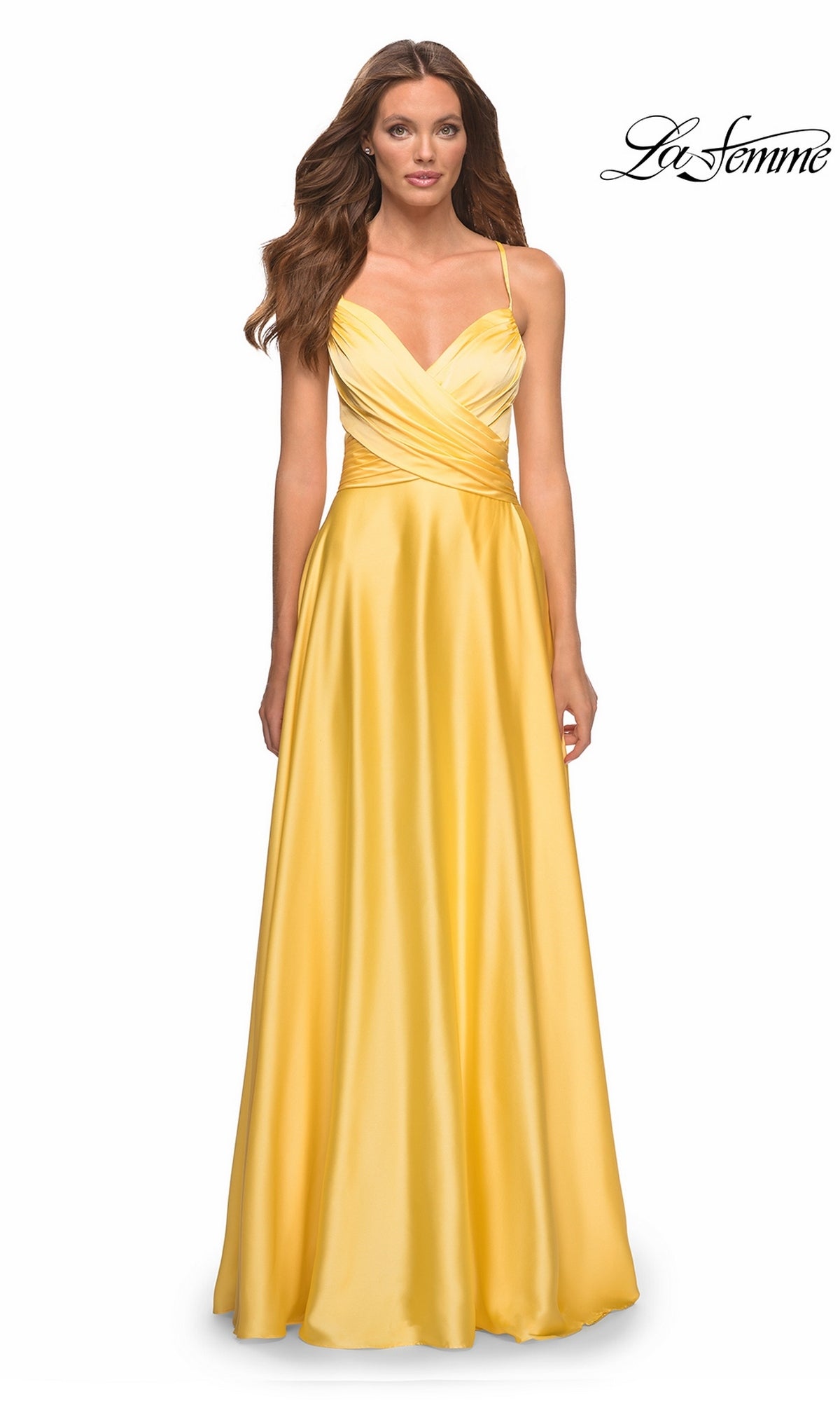 A woman wearing a La Femme 30662 long prom dress in yellow, featuring an A-line silhouette, a V-neckline, and a wrap-style bodice.