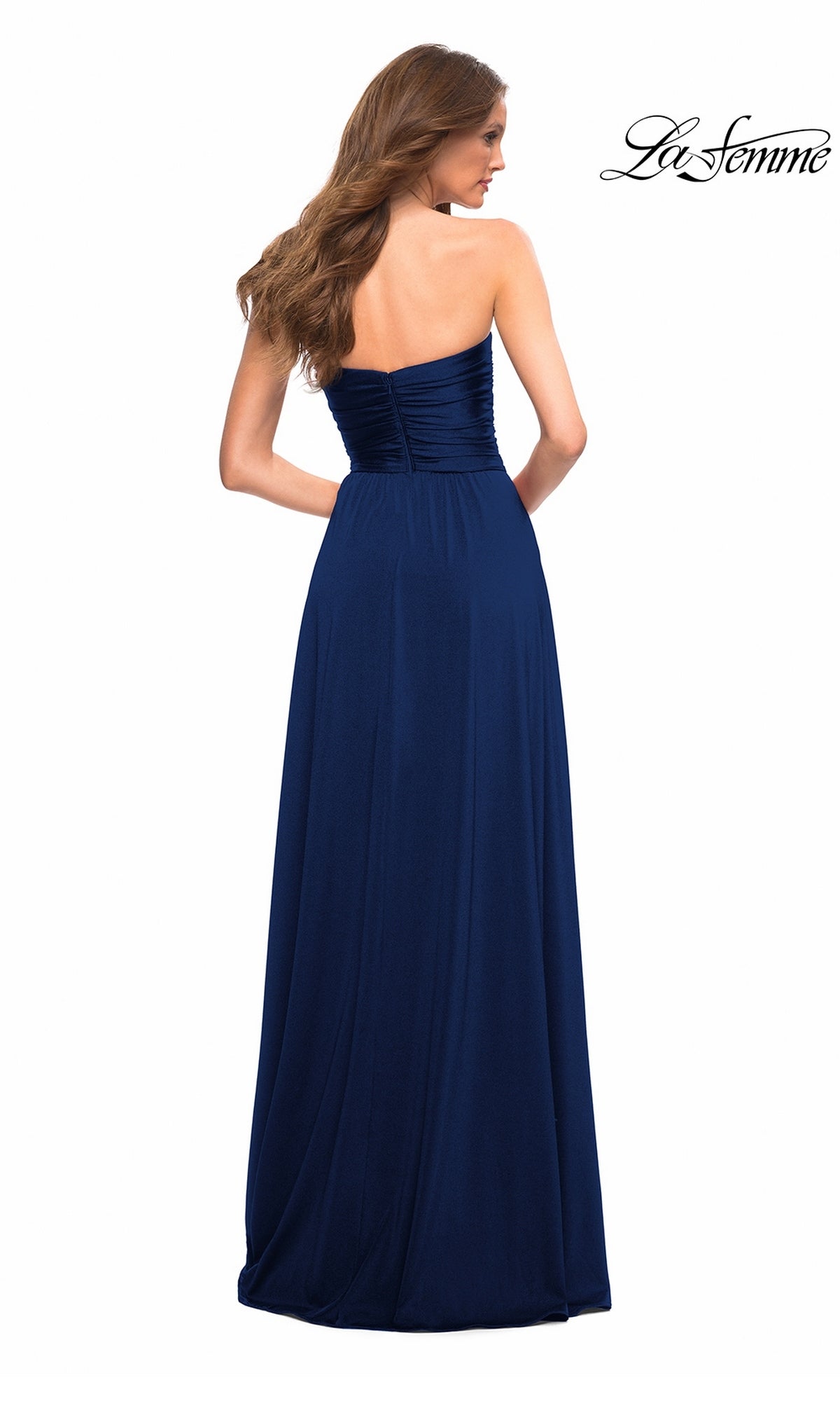 Woman with long brown hair modeling Long Prom Dress: La Femme 30700, strapless with high-leg slit, shown from the back on white. “La Femme” logo in upper right.