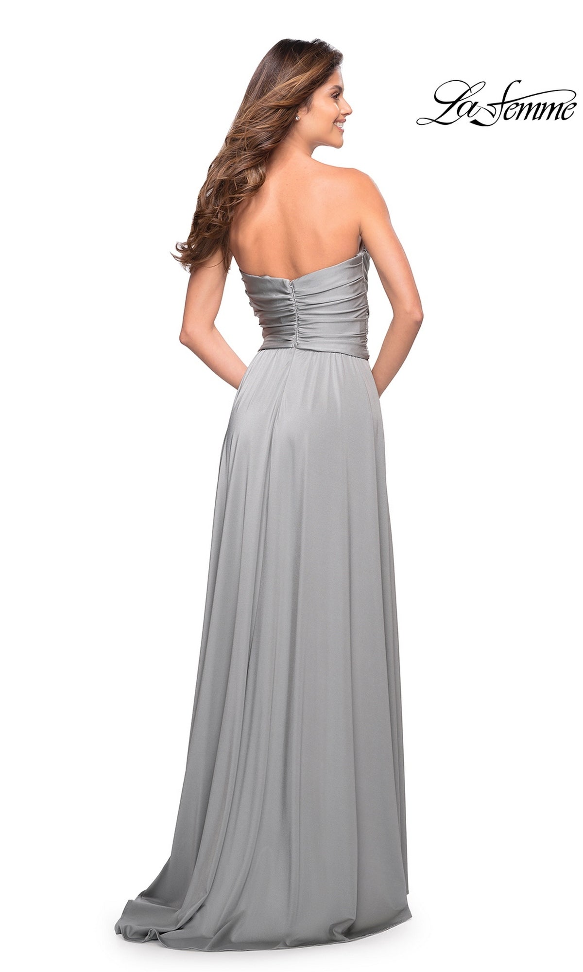 Woman models Long Prom Dress: La Femme 30700, featuring a strapless design, sweetheart neckline, ruching, and flowing jersey skirt. La Femme logo top right.