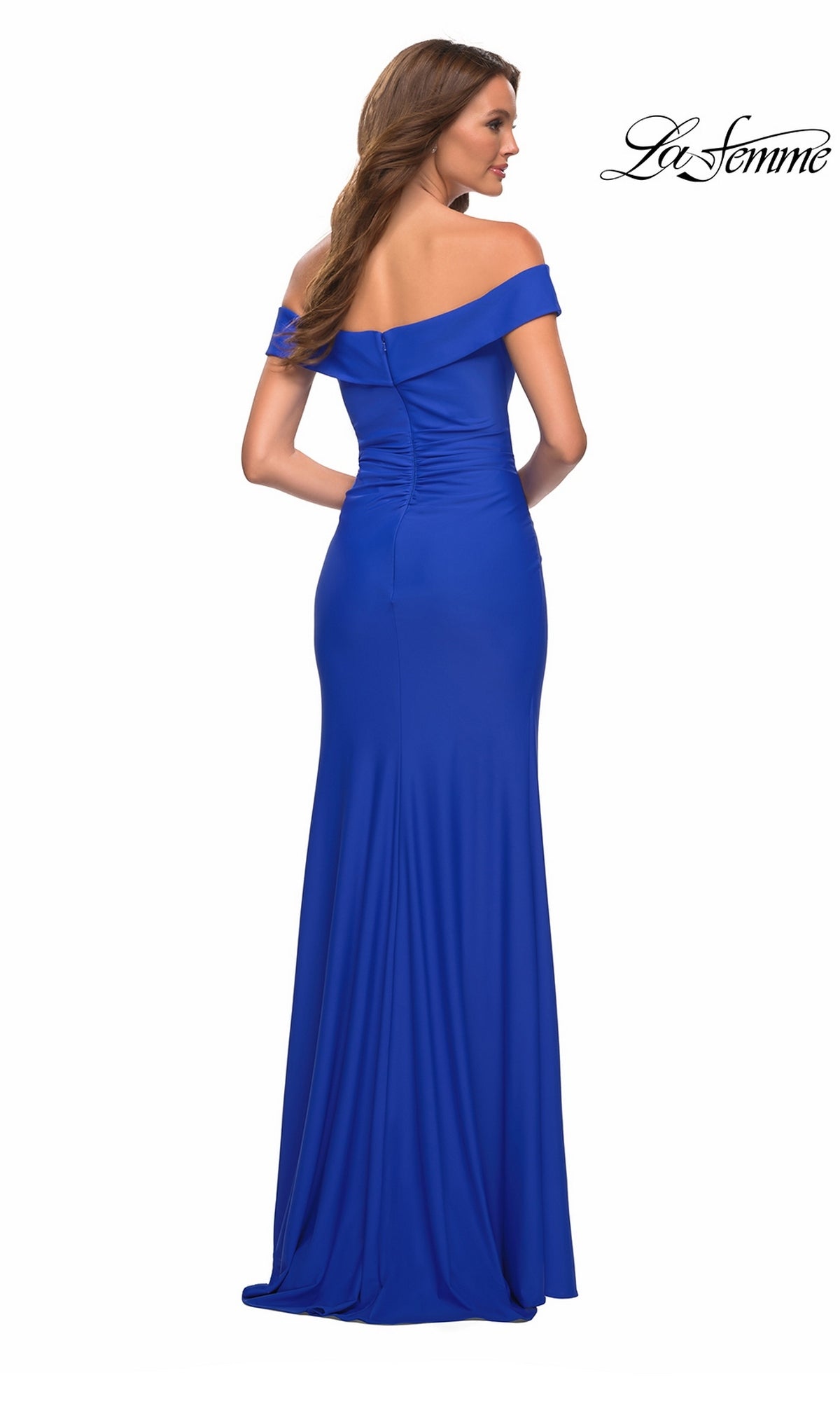 A woman viewed from behind wearing the La Femme 30703 long prom dress, a floor-length, off-the-shoulder royal blue evening gown with ruched detailing on the back.