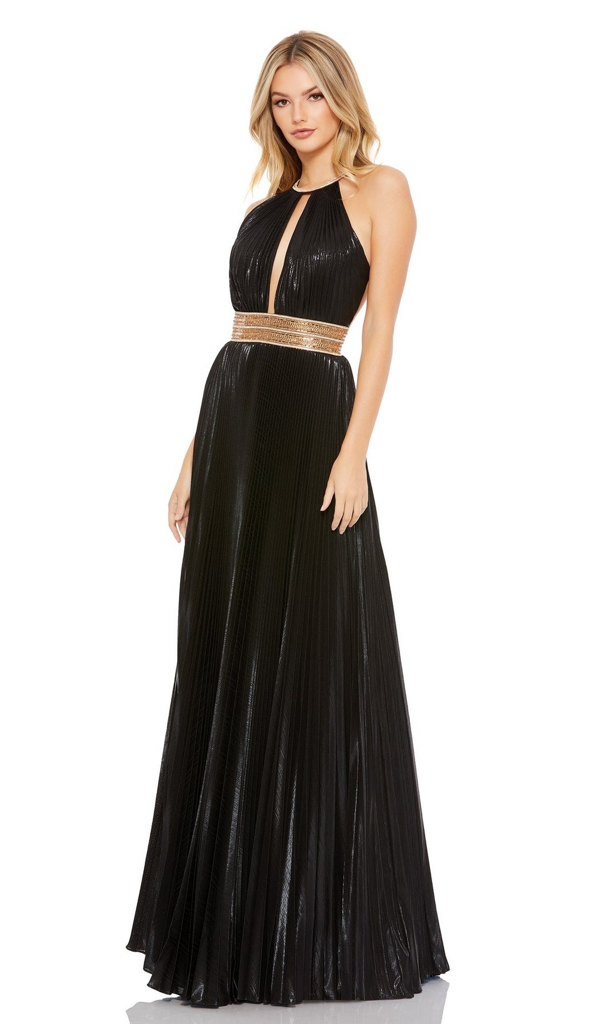 A woman stands against a white background wearing the Long Formal Dress 30722 by Mac Duggal—a black, floor-length, pleated A-line gown featuring a gold waistband and keyhole neckline.