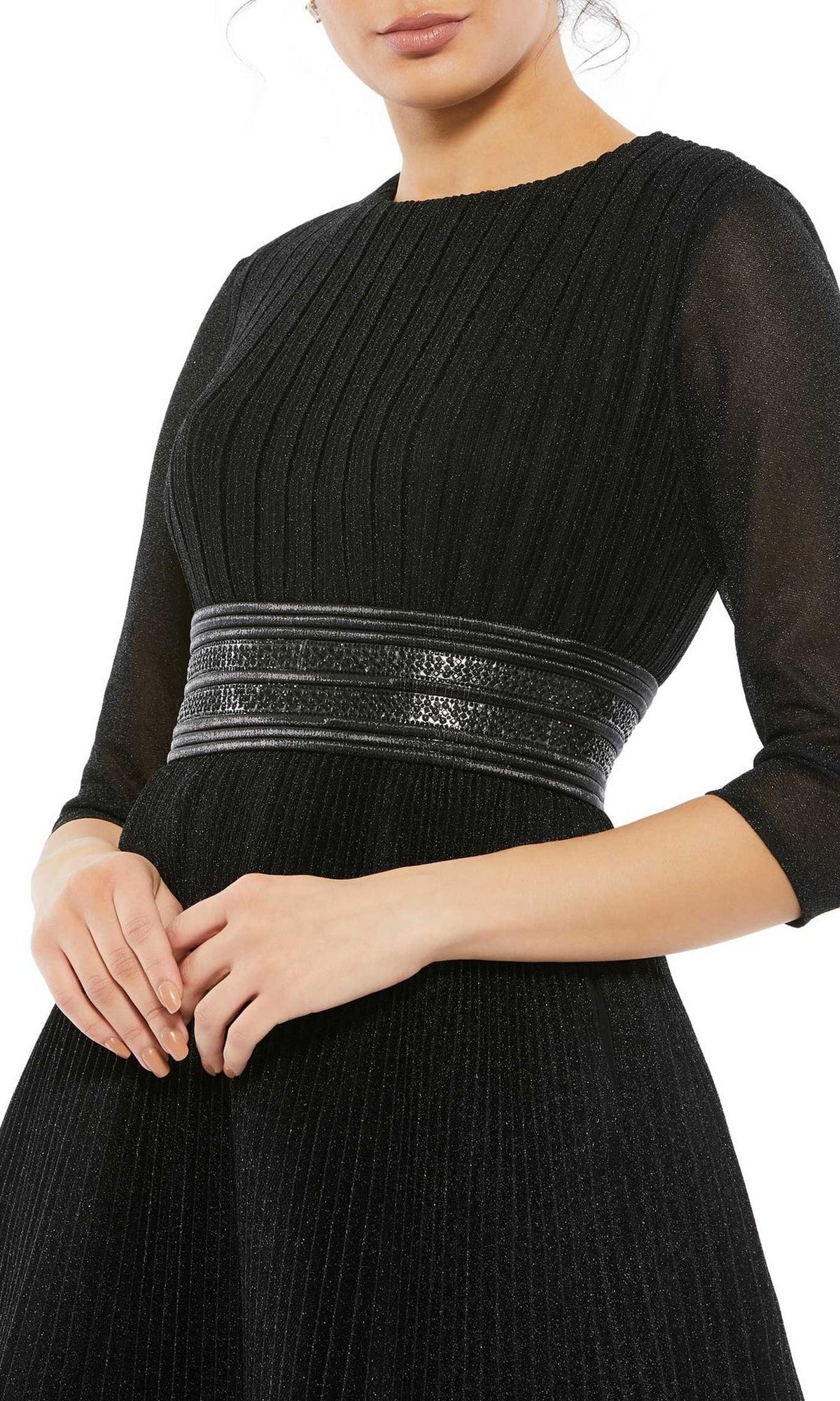Woman wearing the Short Party Dress 30749 by Mac Duggal—a black pleated A-line party dress with three-quarter sleeves and a wide banded waist, shown from shoulders to mid-thigh.