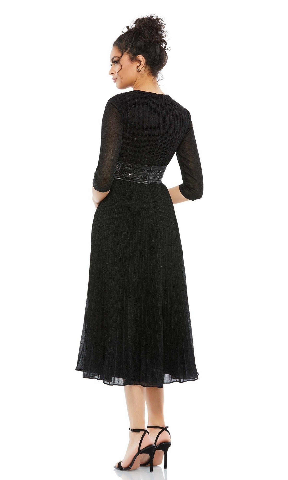 Woman stands with her back to the camera, wearing the Mac Duggal 30750 tea-length wedding guest dress in black with three-quarter sleeves, paired with black high-heeled sandals.