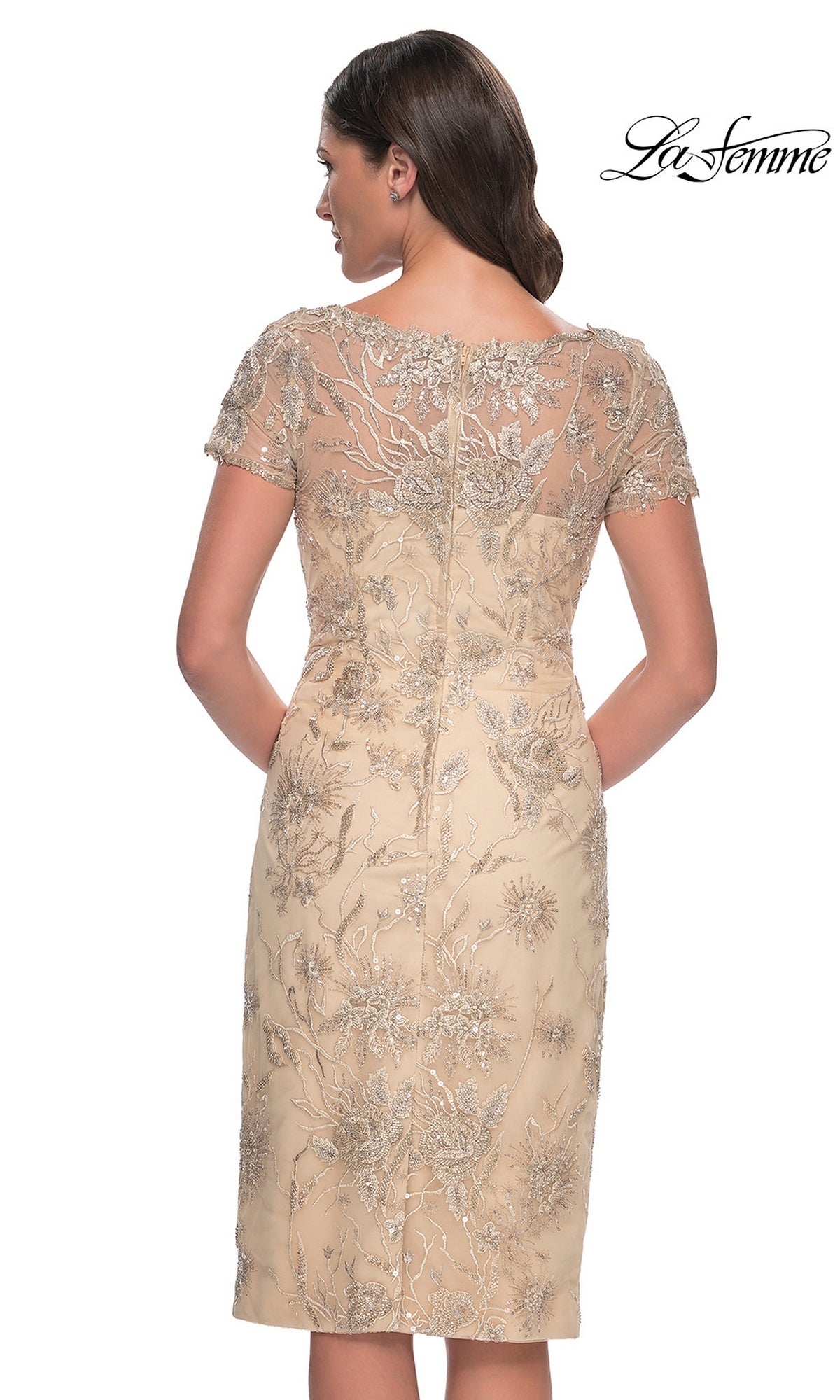 Back view of the Knee Length Wedding Guest Dress: La Femme 30801, a beige, knee-length champagne dress with short sleeves and intricate metallic lace applique embroidery throughout.