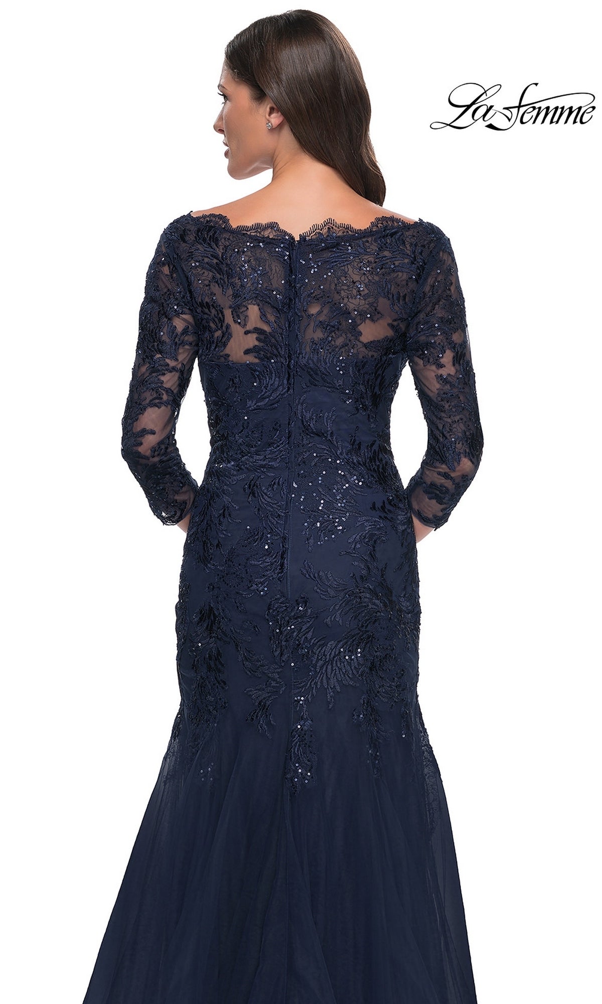 Back view of the Long Formal Dress: La Femme 30823, a dark blue, long-sleeved modest lace mermaid dress with an off-the-shoulder neckline and sequined overlays over a flared skirt.