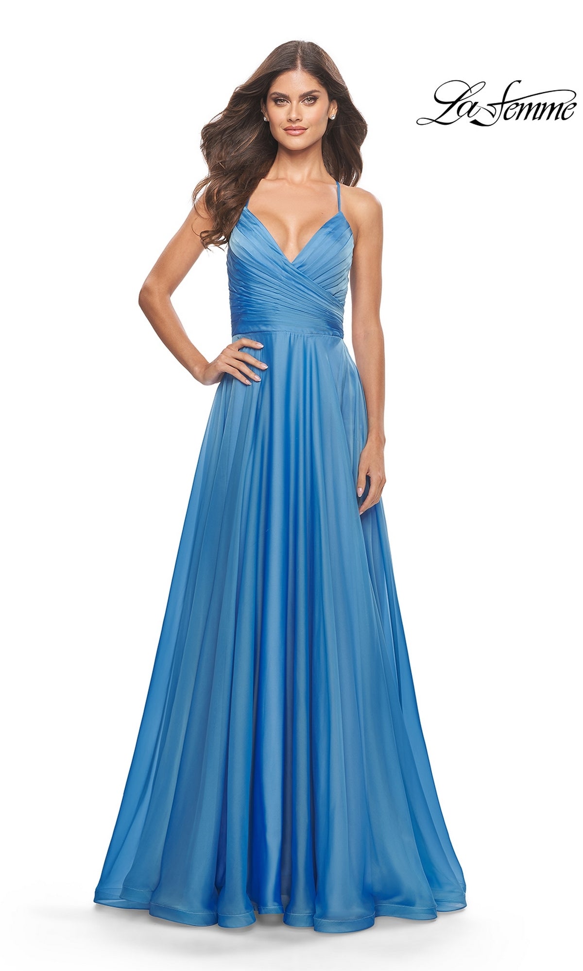 A woman models the La Femme V-Neck Long Tulle Prom Ball Gown 30840, a sleeveless, floor-length light blue dress with spaghetti straps and a V-neckline.
