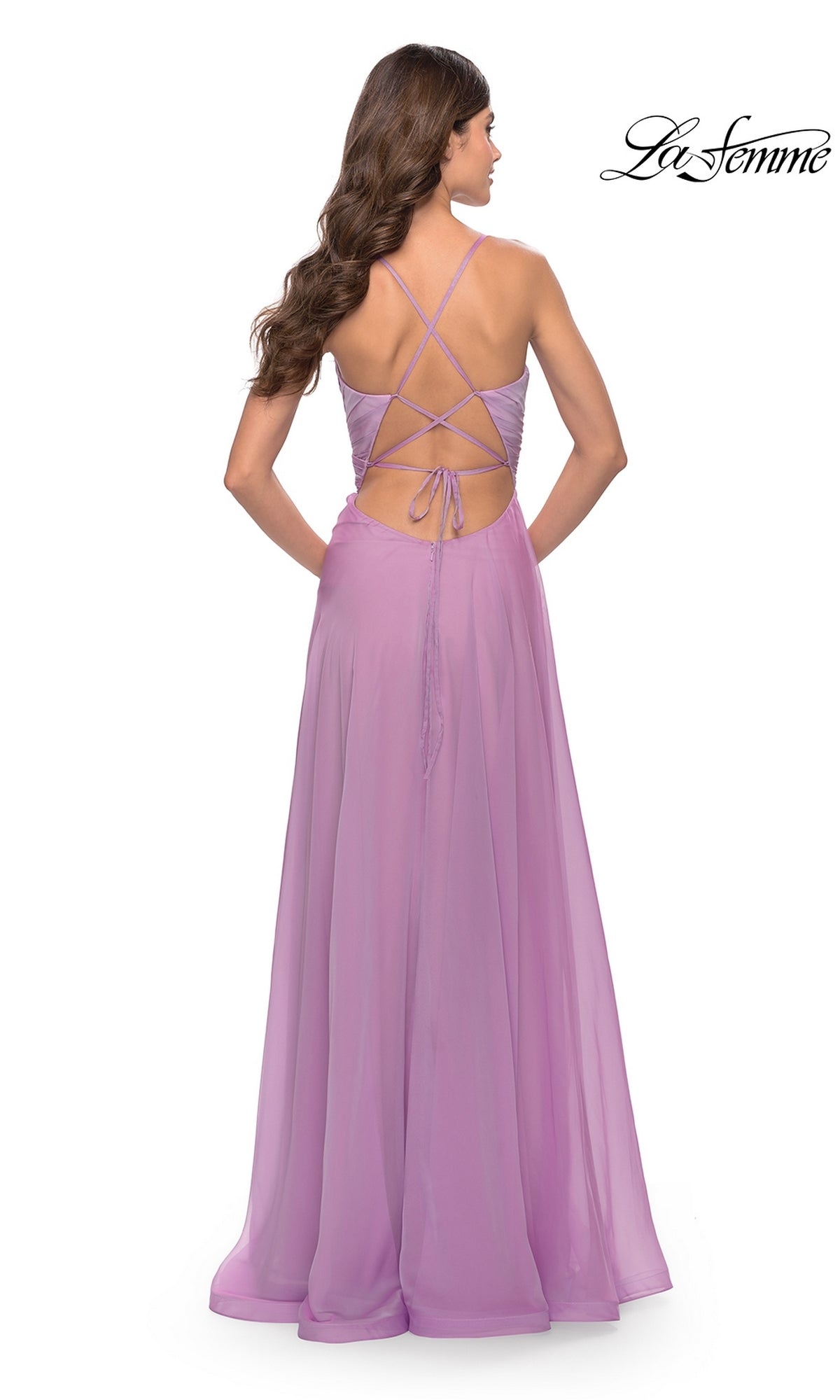 A woman wears the La Femme V-Neck Long Tulle Prom Ball Gown 30840 in light purple, featuring a crisscross open back and flowing skirt, photographed from behind with the La Femme logo in the top right corner.