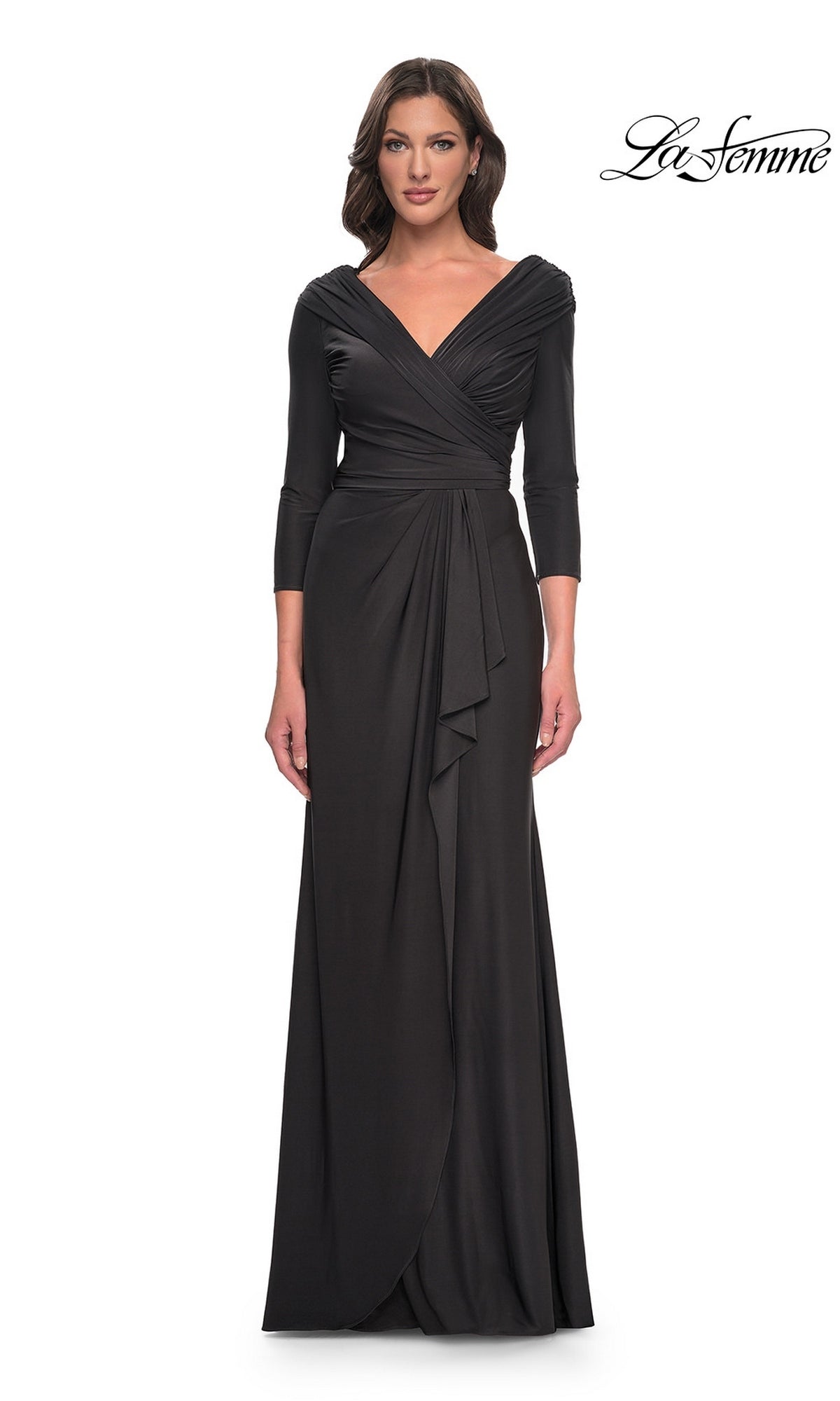 A woman wears a gunmetal La Femme 30845 formal dress featuring a V-neck, ruched bodice, and three-quarter length sleeves.