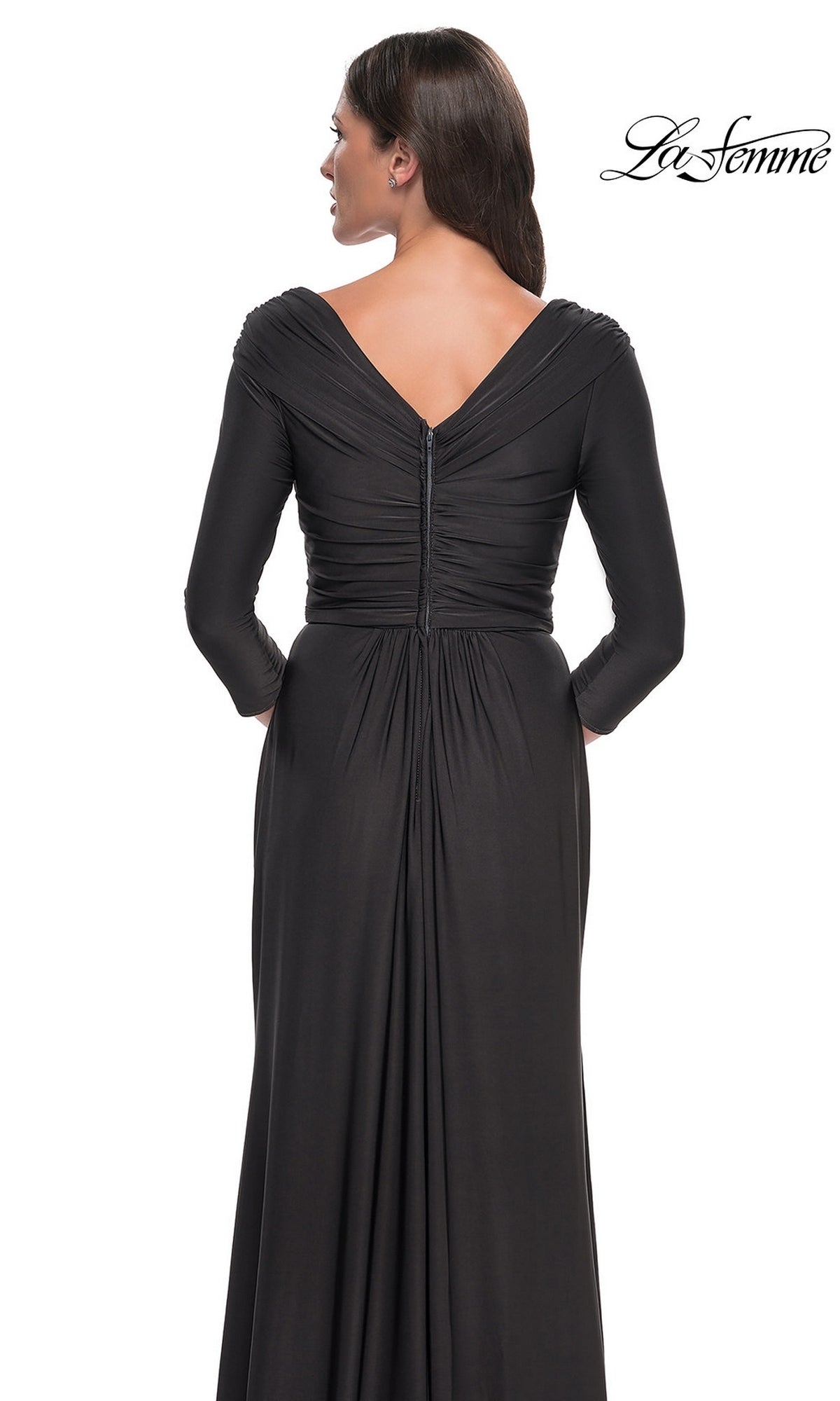 Back view of a woman wearing a floor-length, ruched La Femme 30845 formal dress featuring a V-neckline and three-quarter length sleeves.