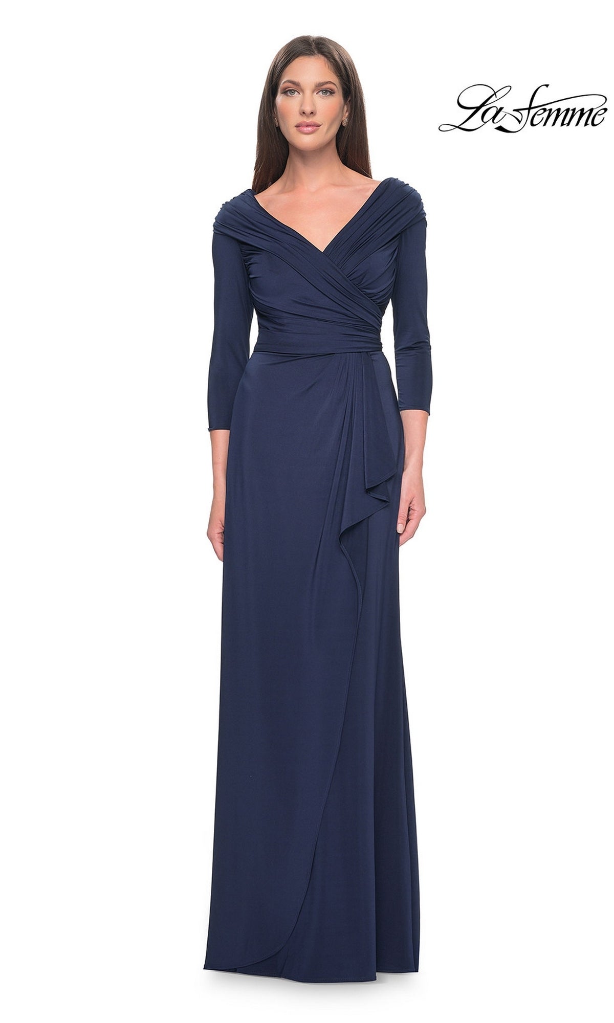 A woman wears a navy, floor-length La Femme 30845 jersey formal gown with a V-neckline, draped bodice, and three-quarter length sleeves.