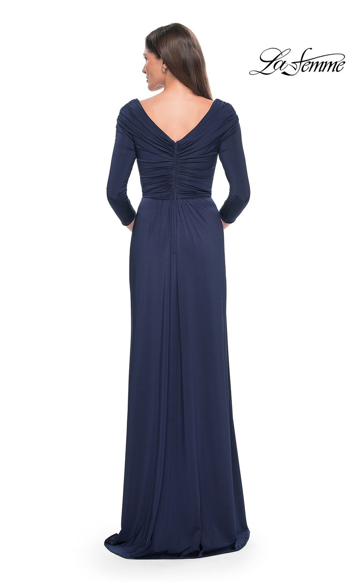 Back view of a woman wearing a navy blue La Femme 30845 formal dress with three-quarter sleeves and a ruched V-back.